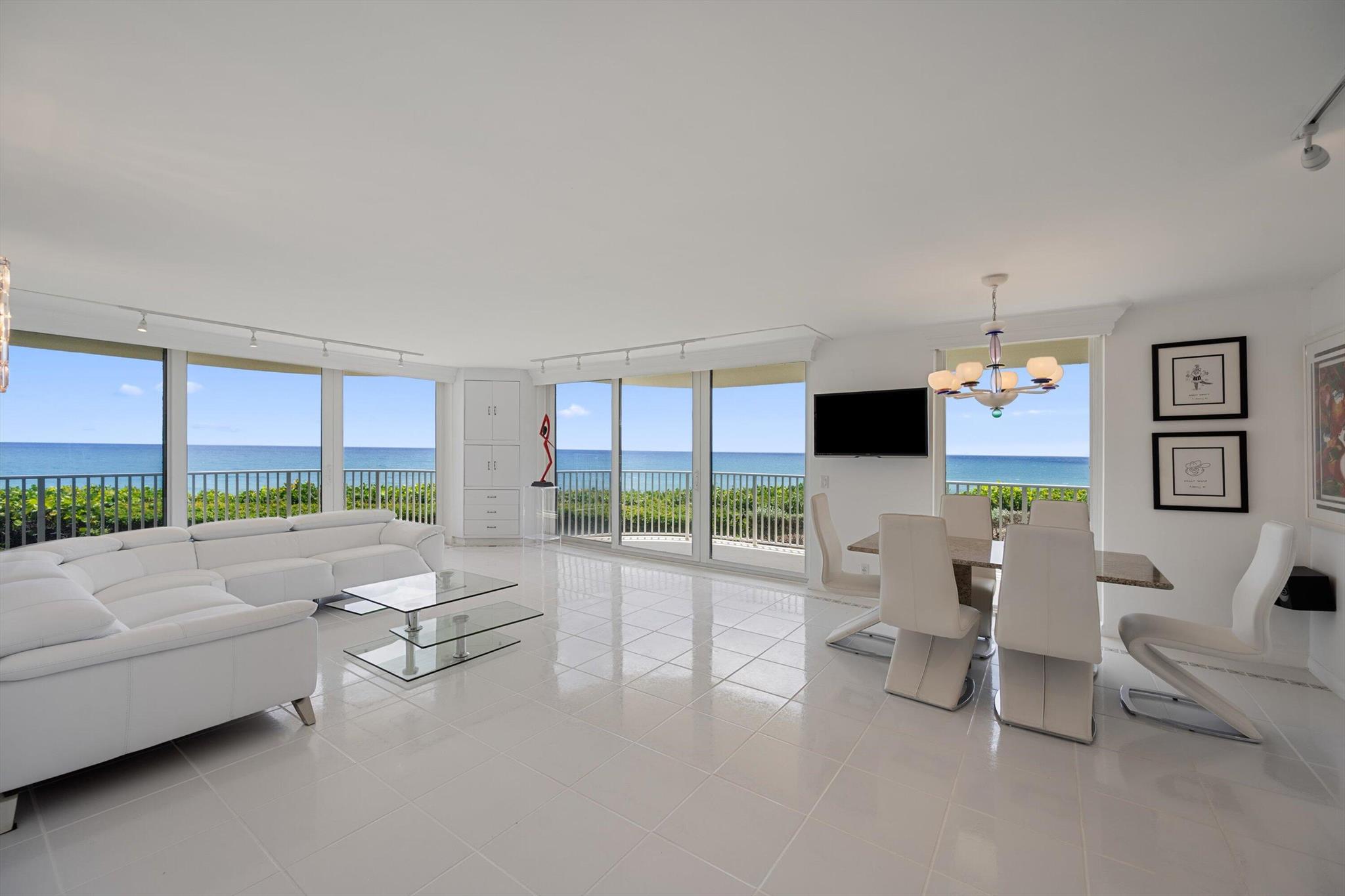 Enjoy panoramic ocean views from every room of this tastefully renovated contemporary 2BR, 2BA residence. Located in the most desired 'E' line, this serene unit has floor-to-ceiling impact sliders which open to East and South terraces, perfect for morning coffee and sunrises. Features include a renovated eat-in kitchen, a primary suite with walk-in closets, updated baths, and a full sized laundry room.Located in a full-service oceanfront building with a doorman, fitness center, garage parking, two tennis courts, salt water pool, and new beach access. Minutes from Palm Beach Par 3 Golf, Worth Avenue, fine dining, and luxury resorts.