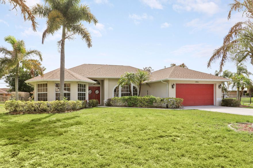 Spacious CBS 3 bedroom 2 bath plus large private family room/den pool home that sits on a 1/3 acre fenced corner lot in the heart of Port St Lucie. Relax on the 25 x 10 covered screened porch and take a swim year-round in the solar-heated pool. The upgraded kitchen includes space-saving wood cabinets, granite countertops, stainless steel appliances and a pass through window to the outside enteriaining/pool area. Additional features and upgrades include a new roof in 2020, accordian hurricane shutters which cover almost every window and door, vaulted ceilings, plantation shutters, a sprinkler system, a hot water heater (2022), pull down attic stairs which offer additional storage, and a child safety pool fence.   Additional interior features include both a formal living room and a spacious 20 x 14 family room/den with bay windows and double french door entry for added privacy.  Choose to serve your meals in the formal dining room, the breakfast bar off the kitchen or in the covered screened porch/pool area. Master bedroom has two walk-in closets. Master bath has separate tub, separate shower, and dual sinks. The living area has been updated with laminate wood flooring (the higher-end glue-together style). The exterior is equipped with accordion shutters on all windows except the bay window, dining room and den (that have regular aluminum shutters). Also an accordion shutter that goes across the entire back patio. Excellent curb appeal.