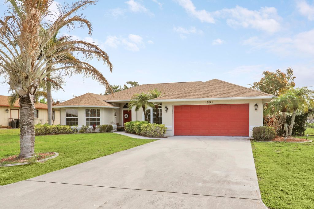 Photo of 1991 SE Manth Lane, Port Saint Lucie, FL 34983 (MLS # B26013277)