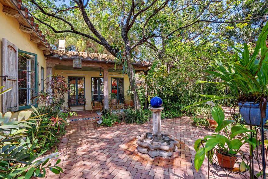 Discover your very own enchanted residence and guest cottage hideaway, secluded in Boca Raton's legendary Old Floresta neighborhood, where history whispers through the banyan trees and every path feels like a secret garden exploration. One of only 29 Addison Mizner-designed Old Floresta homes, circa 1926, the current owners have stewarded this heritage residence and quaint guest cottage since 1975, respecting and preserving the original architectural components that include Dade County pine floors and pecky cypress ceilings, columns and casement windows. The original wood-burning fireplace highlights the residence's living room, and even the original 1926 bathroom fixtures have been preserved.  Period-sensitive details also include wide curved entryways, French doors, plantation shutters and handsome built-in cabinetry. Mexican Saltillo tile floors with accent insets adorn the patio and porch, which is complemented by decorative copper gutters. While preserving and maintaining the vintage charm, the two-bedroom, two-bath residence, spanning 2,078± square feet, stands today curated, updated, improved and expanded for modern living. The extensively remodeled kitchen is finished with custom hardwood cabinets, granite countertops, high-end appliances that include an LP/gas range, and a walk-in pantry extension. The primary suite, an aesthetically pleasing well-conceived addition, is complete with a spa-like bathroom with double sinks and a spacious walk-in shower with a built-in bench. The suite also comprises a walk-in cedar closet, an office/alcove and French doors that open to the pecky-cypress screened porch, an ideal retreat to observe the natural setting. Whether greeting the morning or unwinding at day's end, the changing light highlights the multitude of textures and diverse vegetation. Just adjacent, the open deck is enhanced by an orchid garden and features a 'ships ladder' that gives easy access to the flat roof. A detached structure nestled toward the back of the property comprises a two-car garage with space for a third car, a shop/studio area, while the picturesque one-bedroom, one-bath guest cottage, which is imbued with timeless, storybook charm. Other amenities include storm shutters and a laundry room with a washer/dryer and utility sink. The first time on the market in 51 years, this historic oasis is now available for purchase. DISCLAIMER: Information published or otherwise provided by the listing company and its representatives including but not limited to prices, measurements, square footages, lot sizes, calculations, statistics, and videos are deemed reliable but are not guaranteed and are subject to errors, omissions or changes without notice. All such information should be independently verified by any prospective purchaser or seller. Parties should perform their own due diligence to verify such information prior to a sale or listing. Listing company expressly disclaims any warranty or representation regarding such information. Prices published are either list price, sold price, and/or last asking price. The listing company participates in the Multiple Listing Service and IDX. The properties published as listed and sold are not necessarily exclusive to listing company and may be listed or have sold with other members of the Multiple Listing Service. Transactions where listing company represented both buyers and sellers are calculated as two sales. "No payments made until title passes" Some affiliations may not be applicable to certain geographic areas. If your property is currently listed with another broker, please disregard any solicitation for services. Information published or otherwise provided by seller, listing company or its representatives is deemed reliable but are not guaranteed and subject to errors, omissions, or changes without notice. Copyright 2026 by the listing company. All Rights Reserved.