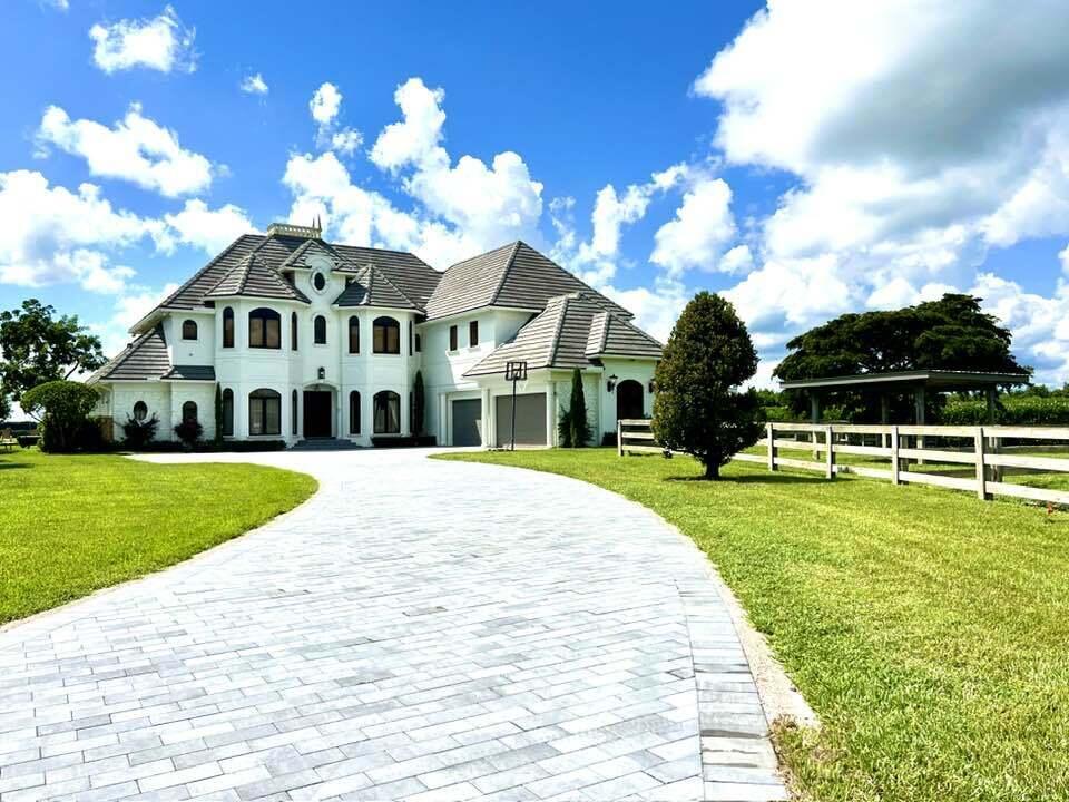 Location, Location! If you love POLO this is the Estate home for you!! Right on the main Polo Fields of the Grand Champions Polo club. Over 2 acres ,horses welcome,AG Property,With a brand new beautifully designed 3/3 guest house just finished in 2025,Main House is a 4/4.2 and has  tons of upgrades, remodeled Kitchen, main house has 2 sets of washer dryers, 2 dish washers, Master bedroom ground floor with New pool and spa, room for barn or tennis court, 5 car garages,gated with stunning views of POLO. Fantastic location in  famous Palm Beach POLO . Golf cart easily to the New horse show grounds . Square footage includes Guest house  2024 roof is for the guest house. Only 15 mins to a major airport and 25 mins to Palm Beach and the ocean. This is a one of a kind opportuny