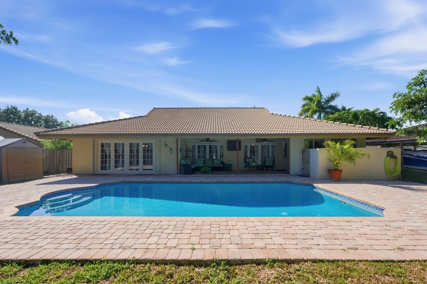 This thoughtfully reintroduced 4 bed, 2.5 bath pool home offers a functional layout w/ inviting living spaces & tasteful updates throughout. Warm wood flooring carries through the main areas, complemented by a well appointed kitchen w/ granite countertops, SS appliances, & a charming bay window breakfast nook. The home features impact windows, multiple living & dining spaces, including a custom bar for everyday living & entertaining. The primary suite is privately situated w/ a sitting area, custom walk-in closet, & a spacious bath w/ dual vanities, soaking tub, & separate shower. Outdoors, a fenced backyard offers a pool, pergola, & space to relax or gather, with room for a boat or water sport toys. A clean, timeless home in the Oakwood community in the heart of Coral Springs w/ no HOA.