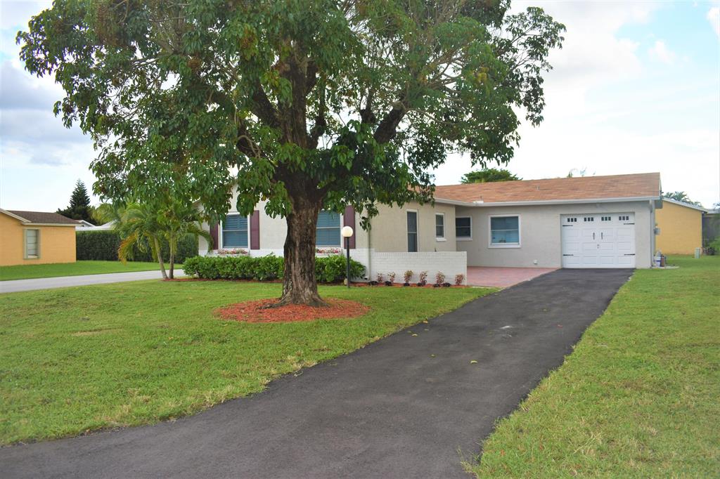 Amazing 2-bedroom, 2-bathroom house in Lake Worth. May even be converted into a 3rd bedroom (Optional). Tons of upgrades with a beautiful warm touch. The general floor plan comes with a mudroom, living room, family room, kitchen, guest bath and guest bedroom with built-in closet shelving, master bedroom and bath with walk-in closet, one car garage with built-in shelving, epoxy floors, washer and dryer and cooled by window AC. Nice quiet community with cable included. Monthly rent will also include a 65-inch Sony TV and weekly lawn maintenance. Two-minute walk to community pool. Right off the turnpike and short drive away from plenty of commercial attractions, supermarkets, great schools, and restaurants.Great amenities .