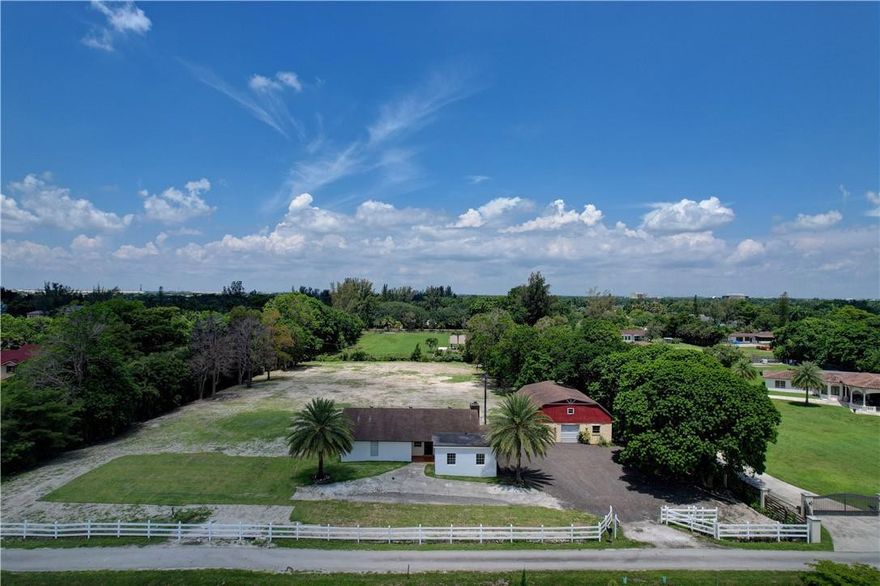 This 2.28 acres lot will not last! Most desirable residential lot in Country Club Ranches. Lot is very wide & deep, & also very private. ASIS. Lot has been filled up 4 feet, to prevent flooding issues. No HOA & No Restrictions. Can park RVs, trucks, trailers, etc. Farm animals & horses permitted. Can use land as a plant nursery. House & barn are both CBS.  Can have 2 total structures. Could make a hallway from main house to the 2-story barn, then subdivide lot & build another home. Needs TLC. Can renovate, build out or build new construction home of your dreams! Newer heightened fence on right side of lot. Mega Mall Miami being built w/ waterparks & 30k+ jobs. Currently 6 bedroom/2 bath, formally 3 bedrooms/2 bath, w/ a 2-car garage. Can easily be converted back. Septic tank & well water. Gigantic lot, plus house & barn, in the heart of Miramar!!!