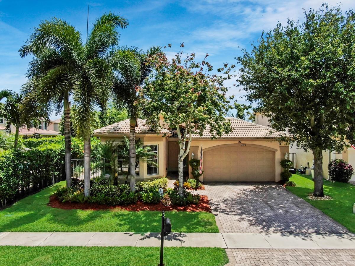 Come experience the warm ambiance and charm in this 4 bedroom, 3 bath home in Canyon Isles. Formal occasions are suitably hosted in the formal living and dining room, while casual gatherings focus in the spacious family room. The chef's kitchen stands ready to host guests with granite countertops, tiled backsplash, under cabinet lighting, stainless steel appliances, breakfast nook and snack bar. Opulent master retreat with a tray ceiling, slider to the patio, his and hers closets, dual sinks, a soaking tub and walk-in shower. Step outside to discover paradise in your breathtaking fenced backyard with an extended patio, tropical landscaping a a serene lake view. Neutral tile, crown molding, a bedroom with an en-suite and an abundance of natural light complete this home.