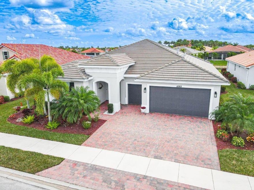 Meticulously maintained, stunningly beautiful and professionally decorated, your dream pool home awaits. Located in the sought after premier active adult community of Vitalia in the master planned Tradition, this resort-style exquisite home will delight the most discerning Buyer. Absolutely every detail has been thoughtfully and impeccably upgraded. The custom designed, solar heated, WiFi automated, auto fill salt system smart pool is not only the largest in Vitalia, it offers 4 distinct features: a lap pool, spa with therapeutic jets, a lounge chair platform and wading area! The lanai is 2,000 sq ft under screen, with loads of spacious areas to sun, dine, lounge and entertain. The picture frame enclosure allows for unobstructed lake views and of the professionally designed landscape. In the evening, your true Shangri-La paradise continues to offer idyllic beauty and tranquility with custom pool and spa lighting of your desired hue, and custom lighting of your landscaping- just spectacular! Neutral tile throughout the 3 BR, 2/1 Bath, with a spacious Den that is washed in beautiful sunlight overlooking the pool and lanai. A true chef's kitchen with double oven, gas stove, expansive quartz counter tops, walk in pantry with new frosted glass door, and a brand new LG (4 K) Refrigerator with WiFi, all stainless appliances, and a newly installed Kohler kitchen sink with 1HP Quiet disposal. The pavers on the lanai, driveway and walkway are freshly sealed, exterior and interior also freshly painted throughout. Gorgeous crown molding adorns the entire home. New, owned water softening and filtration system, new water heater, epoxy coated garage floor with smart garage door openers for the 2 car garage with additional golf cart bay. Front load Maytag washer and dryer set, impact windows throughout and a motorized, 3 retractable hurricane screens across entirety of lanai openings. LED smart lighting and dimmers throughout the home. All artwork, 4 New LED HD TV's, new premium quality new furniture and furnishings will convey. This includes ALL outdoor, premium patio furniture and all pool equipment and accessories. Motorized, remote controlled black-out shade in the Owner's Bedroom. Whole house surge suppressor system for your piece of mind. Constructed November 2016. Close to the beaches, NY Mets Spring Training at Clover Park, great dining, entertainment, shopping and so private yet minutes from I 95 this truly is the Florida Dream! All interior and exterior furnishings and art are negotiable for private purchase.