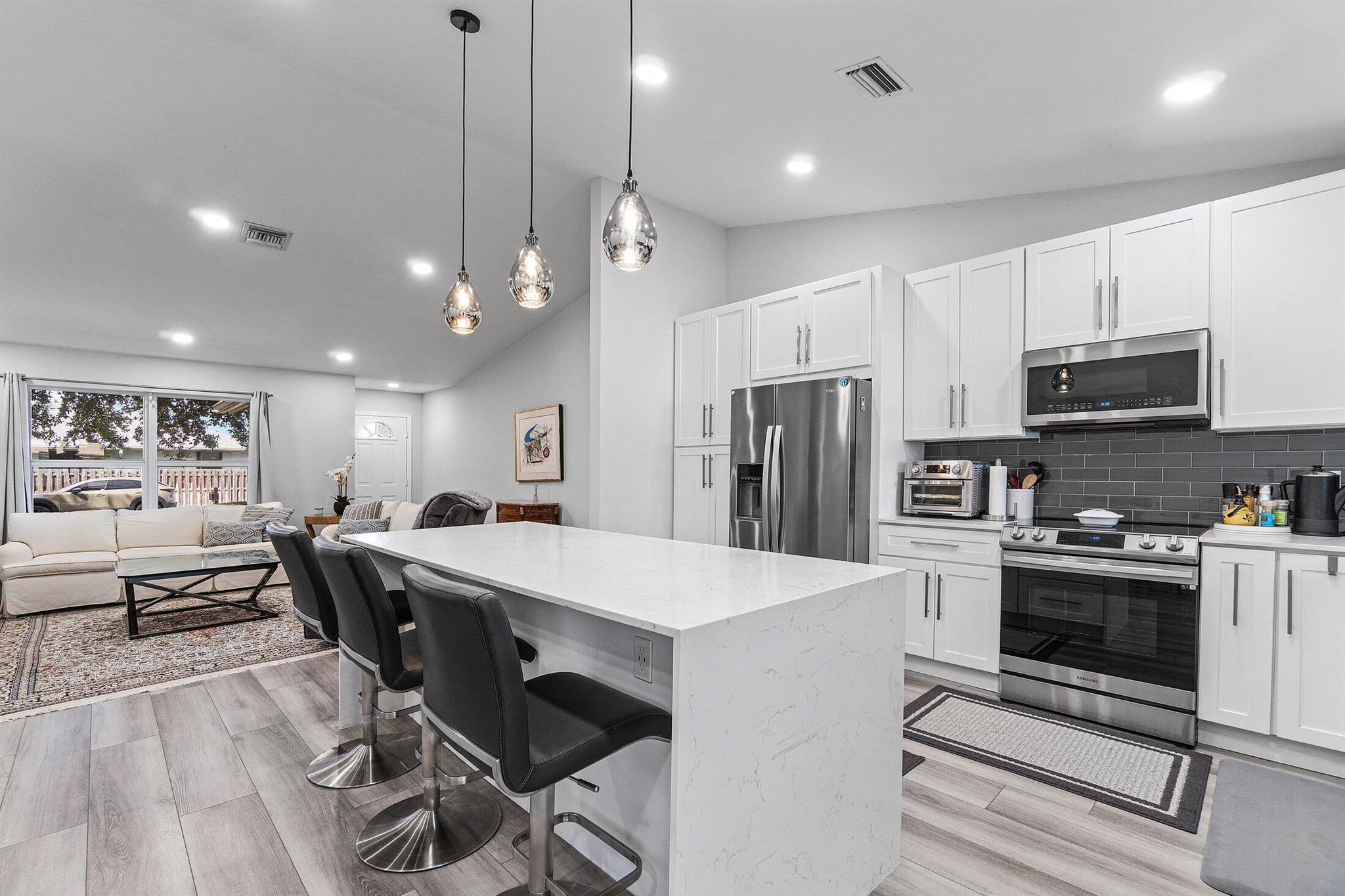 BEAUTIFULLY RENOVATED CBS HOME IN NON-HOA SIDEWALK LINED NEIGHBORHOOD! 2025 HVAC, 2025 Water Heater & More! You don't want to miss this one! Renovated from nearly top to bottom-this home has a newly renovated kitchen with waterfall quarts countertops on an oversized island perfectly fit for entertaining. The living room boasts vaulted ceilings and abundant natural light. A large primary suite offers a beautifully renovated en suite bathroom, walk-in closet as well as additional wardrobe storage. Across the home you will find two well appointed bedrooms and another newly renovated bathroom. Off the back of the home you will find a screened in lanai and a backyard with room for a pool.