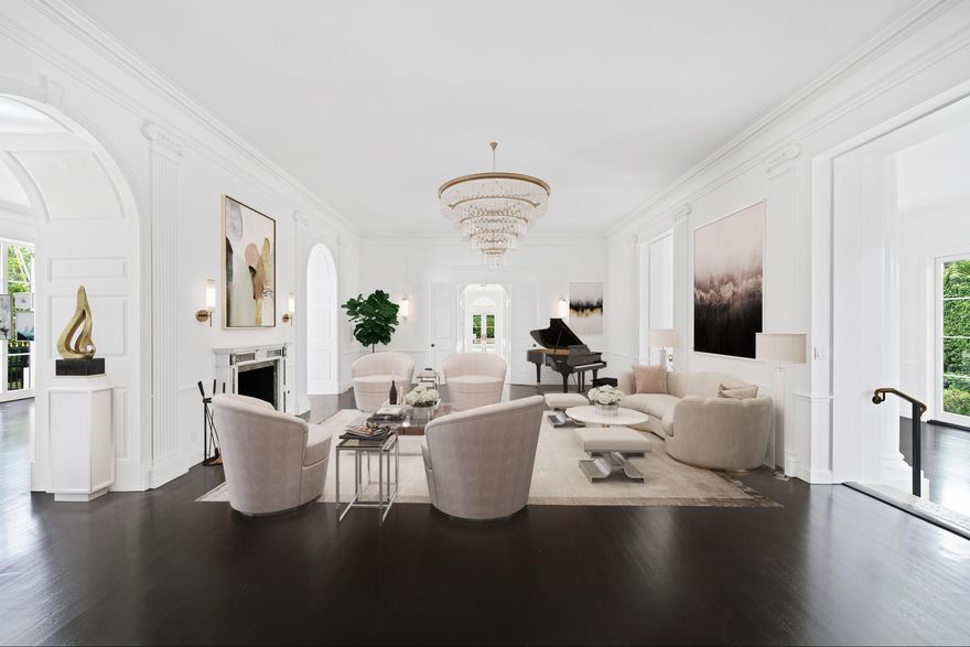 Reimagined by the esteemed Wittmann Builders Corporation, this Clarence Mack Regency home features soaring 12-foot ceilings and grand proportions. Enjoy elegant finishes throughout including solid ebony wood floors, a chef's kitchen with marble countertops and Wolf & Sub-Zero appliances, new impact windows, and a full house generator. French doors lead to the meticulously manicured garden featuring a large covered loggia, a 40-foot swimming pool, and a separate pool cabana with a built-in grill and full bathroom.