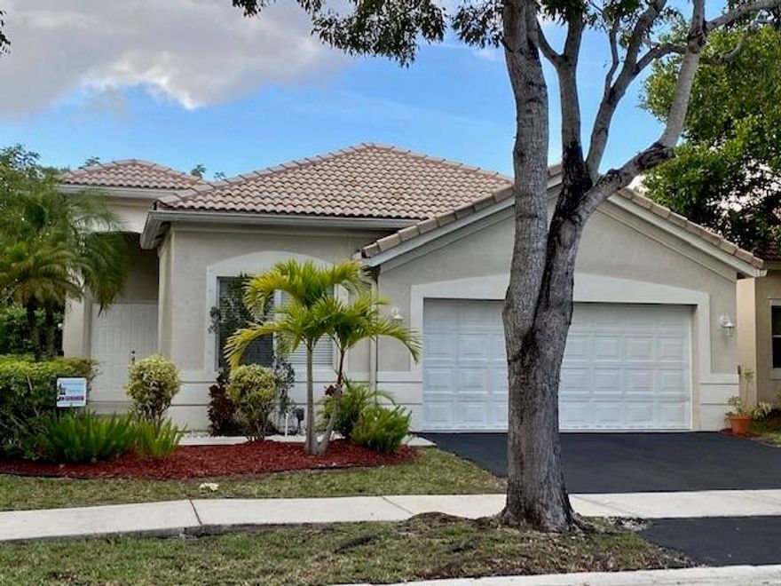 MOTIVATED SELLER. Great Location!This cozy impeccable home features 3 BD 2 BTH Freshly painted inside, dark wood laminate wood floors bedrooms and main living area. Neutral ceramic tile in the family room area. Nice and spacious layout with extended covered elevation in the back patio excellent for entertaining. Laundry inside of the house. Garage floor freshly coated/painted. Nice lawnscaping.