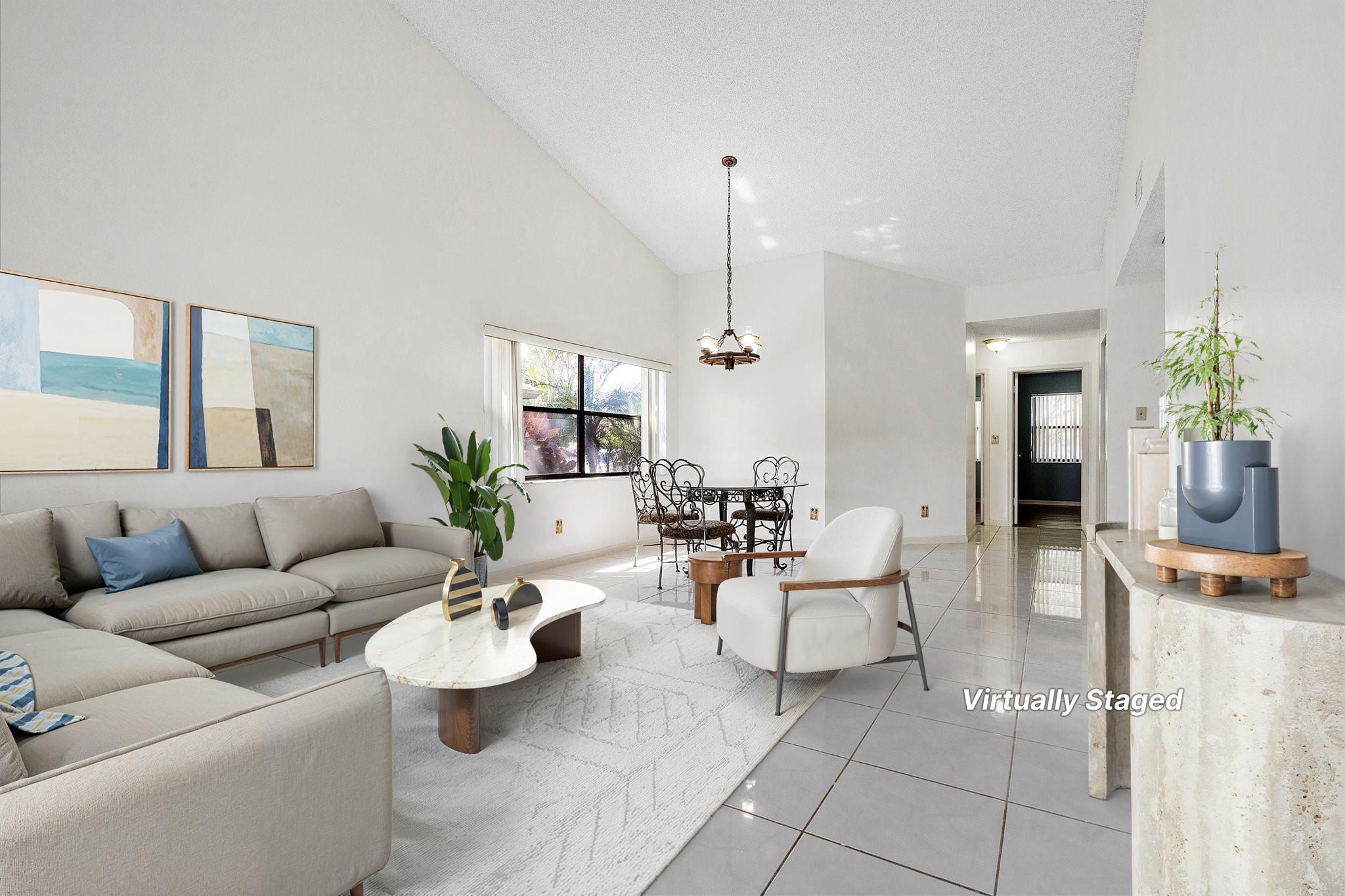Beautiful move-in ready one-level lakefront villa featuring fresh paint, tile in main living areas, and vinyl wood floors in bedrooms. Open floor plan includes updated kitchen countertops, laundry in pantry, and access to a covered screened patio from the living room and primary suite. The primary offers an ensuite bath and walk-in closet, plus extra patio storage. Enjoy serene lake views with lush tree cover. Grenadier Lakes at Welleby provides 2 assigned parking spaces, pool, clubhouse, tennis courts just across the street and the HOA fee includes building/structure insurance. Conveniently located near Oakland Park Blvd, shops, dining, Sawgrass Expressway, and more.