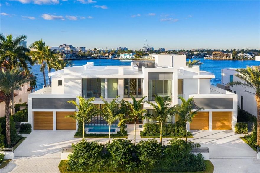 ONE OF A KIND custom home in prestigious Harbor Beach! This modern masterpiece was designed by Randall Stofft Architects & built by prestigious Sarkela Corp. No expense was spared, features include DuChateau oak floors, Italian cabinetry, 2-story marble fireplace, Dornbracht bath fixtures, 200 bottle wine cellar & Crestron smart home system. Being offered turnkey w/signature Terzani chandeliers, imported custom furniture & artwork, + generator. Open floor plan w/impressive great room, club room, eat-in kitchen w/high end appliances & separate prep kitchen. Oversized master suite w/his & hers bathrooms. Awe-inspiring Intracoastal views draw you outside to the generous outdoor entertaining space w/outdoor kitchen, lap pool & vast covered areas. Minutes to the ocean, dock your mega yacht here