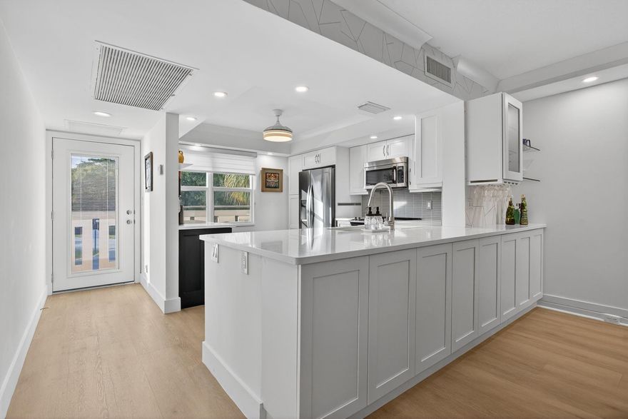 Beautifully renovated 2/2 condo with exquisite details throughout! Unit features impact windows and doors, AC noise-reduction system. Open-concept kitchen with shaker cabinetry, quartz countertops, oversized granite sink, and st/steel appliances. Gorgeous bathrooms with architectural style cabinetry, the master bath includes a Langpa bidet/toilet system with remote control. Crown molding and waterproof vinyl flooring throughout the condo. Wynmoor offers a clubhouse filled with clubs and classes, a bistro, pickleball, tennis, billiards, bocce, heated pools, hot tub, resistance walking pool, BBQ stations, 18-hole executive golf course, movies, and weekly shows. Enjoy convenient shuttle service within and beyond this gated, secure community, all just minutes from shopping and fine dining.