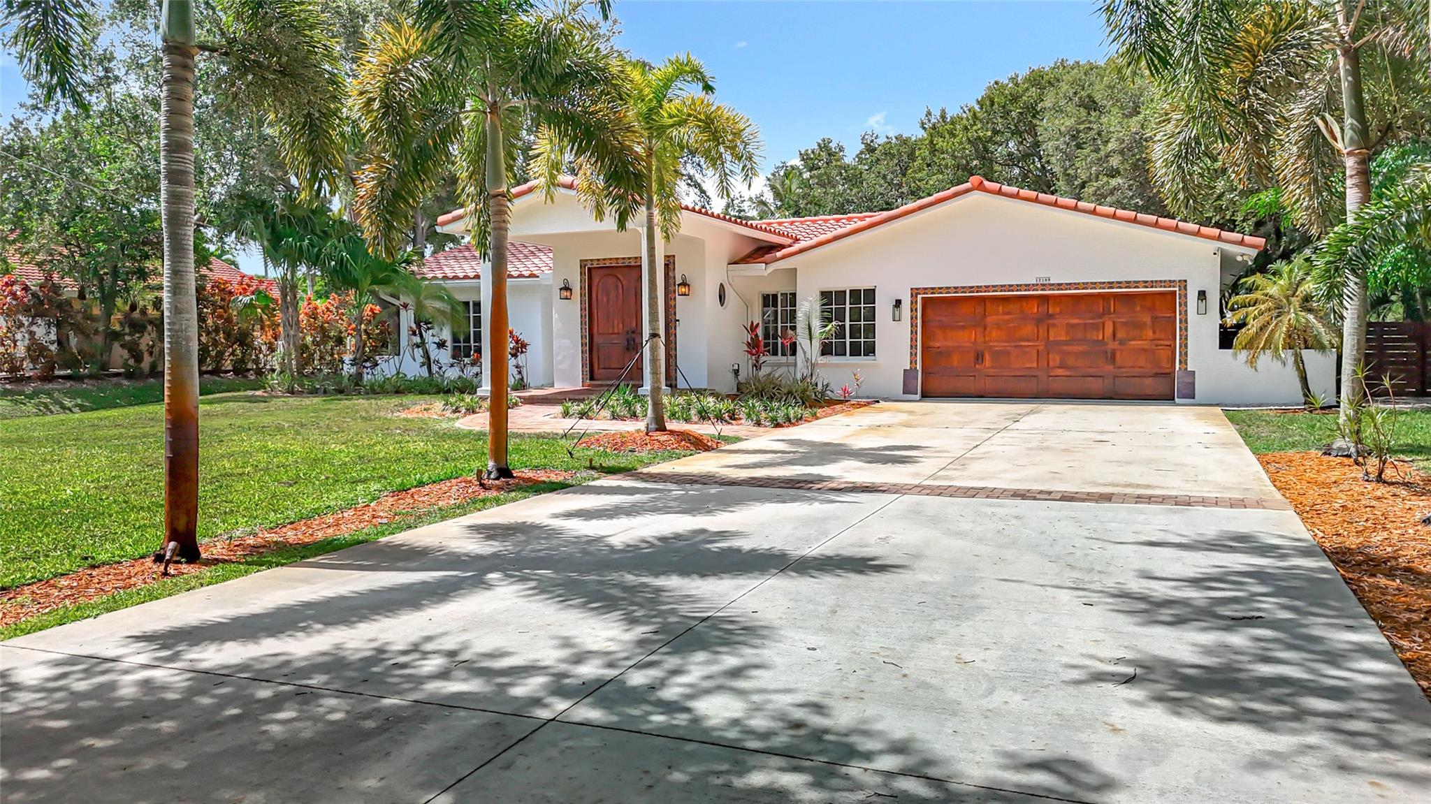 Discover this beautiful home nestled in the heart of Plantation Builders Acre on a generous one-acre lot along a quiet street adjacent to canal. West of 118 AVE. Enjoy the convenience of being close to upscale shopping, fine dining, and easy highway access. Families will appreciate the excellent local schools, including American Heritage school. Open concept living and dining area flows seamlessly into a modern kitchen complete with an island and all offering a tranquil view of the pool. The home is designed with impact windows and doors for added safety and energy efficiency. Fruit Tree two-car garage with new epoxy floor, Planty parking in driveway. Walking distance to American heritage