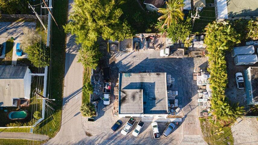 There are three lots (7,8,9) The property is locate on a corner fenced lot. Zoned commercial and residential. It has a building with an office, bathroom and extra room. It has a show room. Storage space for equipment with extra room and bathroom, paved lot, easy parking.