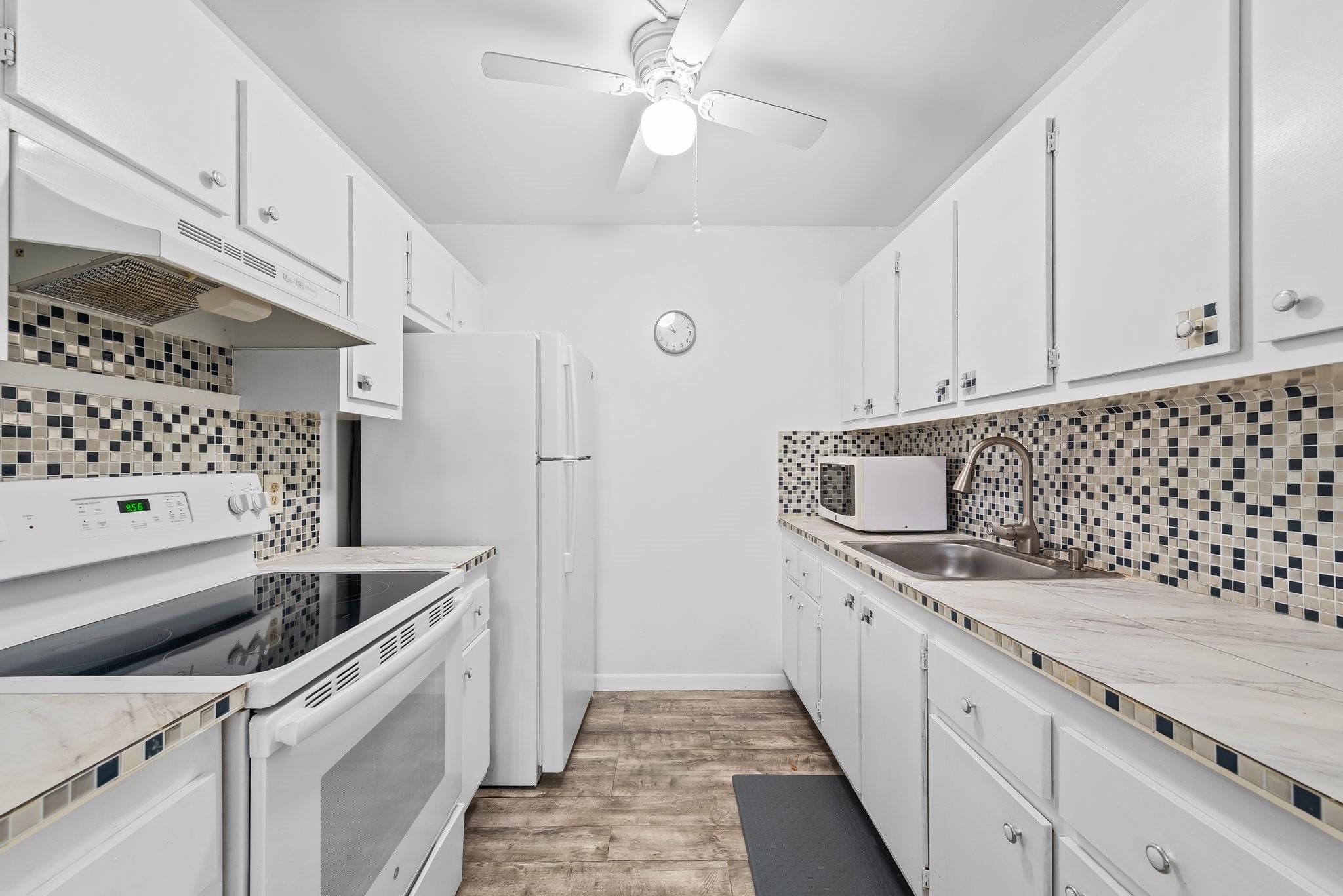 Move-in ready! Beautiful first floor unit with spectacular water view. Updated kitchen, flooring, and baths, AC 2025, IMPACT WINDOWS, tankless water heater, parking directly in front of unit for easy access. Community boasts luxurious clubhouse complete with theater, bingo, billiards, pool, sauna, gym, golf, tennis, pickleball, courtesy bus and so much more! Ideal location, minutes from shopping and popular restaurants. Won’t last!