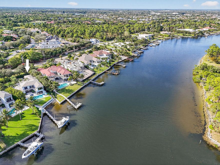Set behind the gates of an intimate waterfront enclave, this beautifully renovated Intracoastal estate offers a rare blend of scale, privacy, and lifestyle. Positioned on an expansive three-quarter-acre lot with direct, east-facing water frontage, the home captures sweeping views of South Florida's most coveted waterway from multiple vantage points. Designed to feel both inviting and expansive, the residence features approximately 5,000 square feet of living space with six bedrooms, four six baths, and two half baths, complemented by a three-car garage. Multiple living and entertaining areas allow for comfort and privacy, making the home equally suited for quiet evenings or hosting family and friends. Outdoor living is a true highlight, with amenities curated for both relaxation and recreation. Enjoy a heated pool and spa, a low-maintenance turf yard with a private putting green, and your own dock complete with a 40,000-pound boat lift and private beach area an exceptional setup for boating and waterfront enjoyment. Located in the heart of Palm Beach Gardens within the prestigious Palm Beaches, the property is just about a mile from the Atlantic Ocean's pristine beaches and offers effortless access to world-class dining, upscale shopping, vibrant nightlife, and major roadways including I-95. A rare opportunity to own a turnkey Intracoastal home in a premier gated community this is waterfront living at its most refined and rewarding.
