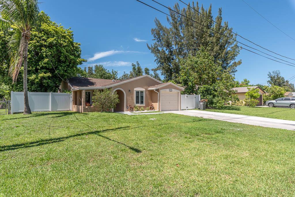 Welcome to your new home! Fall in love with this Beautiful fully fenced SFH in the heart of West Palm Beach. This house sits on a oversized lot on a canal offering Fresh paint, updated bathrooms, beautiful flooring throughout the entire house, SS appliances, brand new dish washer, Granite countertops, Fishing doc on the canal. This house has one car garage and a long driveway for extra parking. Don't miss this opportunity. Close to PBIA, I95, shopping and dinning.