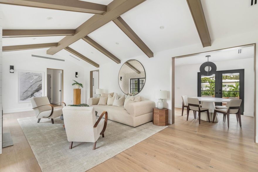 Completely reimagined, expanded, and masterfully renovated, this concrete-block residence offers 3 bedrooms and 2 baths across nearly 2,800 sq ft of light-filled living. South-facing rooms showcase soaring beamed ceilings, wide-plank oak floors, and floor-to-ceiling windows. A chef's Thermador kitchen features custom cabinetry, marble counters, and a waterfall island. All new systems--roof, plumbing, electric, windows--plus security cameras and built-in sound. Set on a 7,800+/- sq ft lot, moments from Palm Beach Island, beaches, dining, and the golf course.