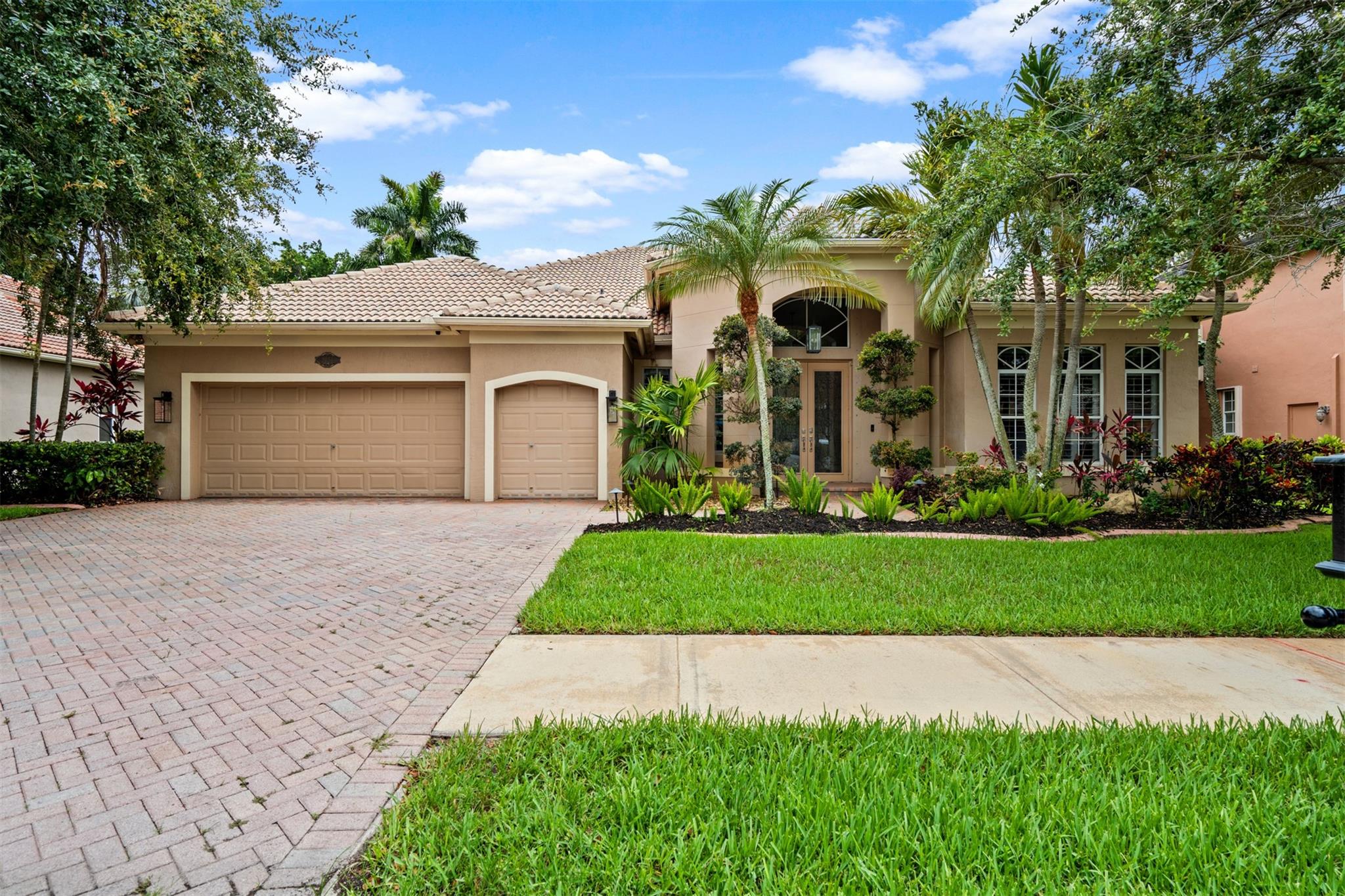 Immaculate turnkey single-story residence in an exclusive, gated enclave of 225 luxury homes, close to A-rated schools and premier dining/shopping. Open split floor plan perfect for entertaining with soaring ceilings and tons of light, plantation shutters, crown molding, wetbar and more. Primary suite features French-doors, wood floors, custom closets, and a gorgeous en-suite bath. Large secondary bedrooms. 4th bedroom is currently used as an office with custom built-ins. Private, lush oversize lot is a tropical oasis; custom free-form pool with waterfall, sun shelf and fire bowls. Beautiful gazebo with grill, bar, refrigerator, wine cooler and stereo. HOA includes access to the Grande Oaks executive 9-hole golf course and NSU tennis courts. (3rd garage space is designed for a golf-cart)