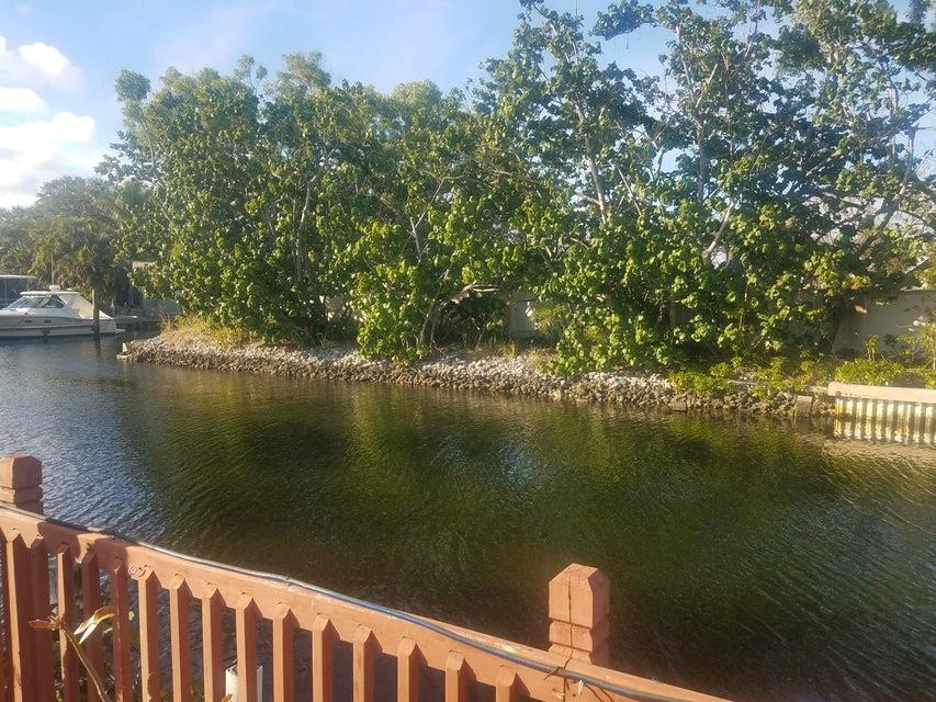 This Property Has 100 Ft Of Water Frontage Located A Few Lots Off The Intracoastal & Next Door To Multi Million Dollar Homes. Some Features Include PRIVATE Water Views On Deep Canal, No Fixed Bridges, Intracoastal Views From Back Yard, Low County Only Taxes, Pool, Boat Ramp In Back Yard, WALK To Restaurants & In The Heart Of ALL Palm Beach Gardens Has To Offer. Can Hold A 65 Ft Boat Just Like The One Next Door To This Lot. The 2,214 living Square Foot One Story House On Property Can Be Rented As Is Until You Get Plans. For The Custom House You Have Been Wanting. You Would Have Nice Intracoastal Views From The 2nd Floor Of Your New Home.Current Home Has Accordian Shutters.