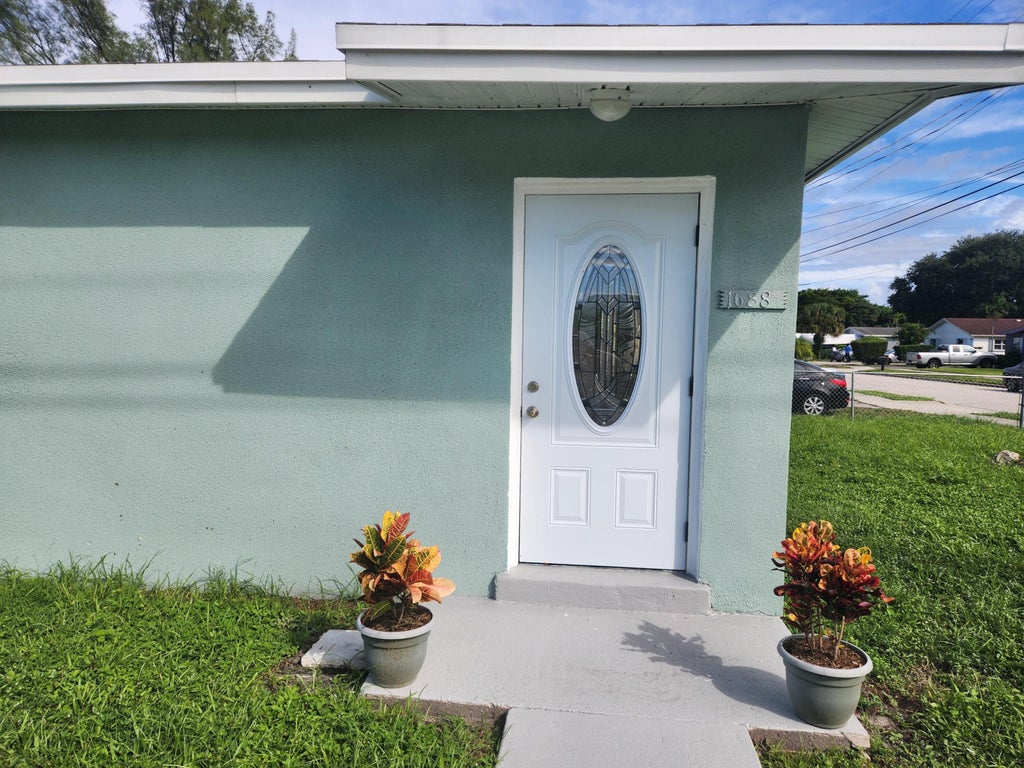 Photo of 1688 W 10th Street, Riviera Beach, FL 33404 (MLS # B26091327)