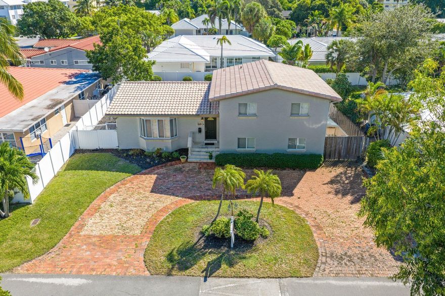 Situated in the heart of the highly sought-after Coral Ridge neighborhood, this elegant 4-bedroom, 3-bathroom tri-level residence offers timeless style, comfort, and architectural character on a generous lot. Soaring vaulted ceilings with exposed beams create a bright, airy ambiance. The chef's kitchen overlooks a private backyard oasis and features stainless steel appliances, custom cabinetry, and granite countertops--perfect for both everyday living and entertaining. Updates include new A/C (2023), water heater (2023), impact windows and doors with accordion shutters, and a durable S-tile roof. Enjoy a resort-style pool, outdoor bar, and expansive yard. Don't miss this rare opportunity in one of Fort Lauderdale's most desirable neighborhoods! Schedule your private showing today!