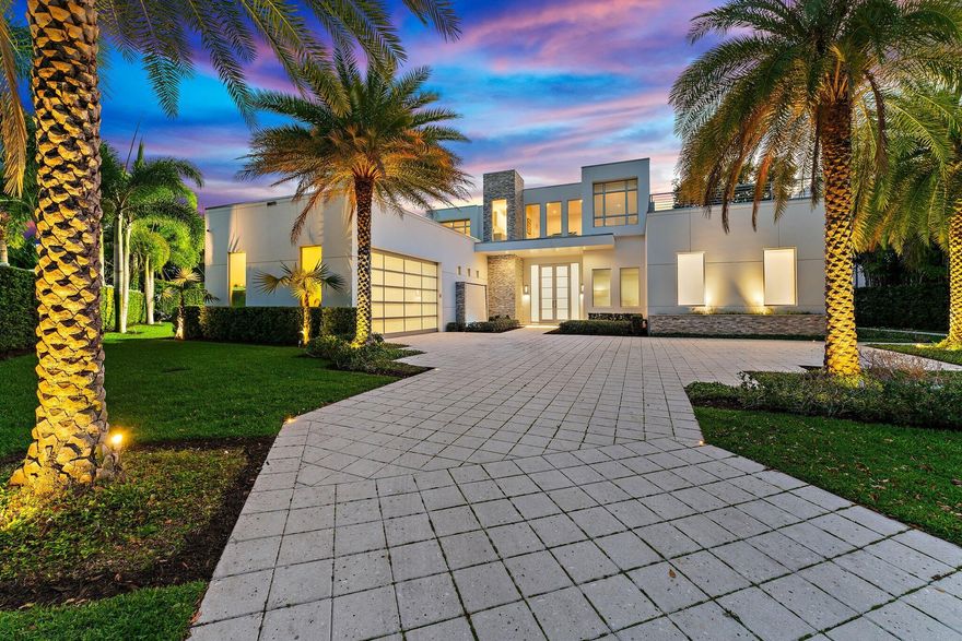 Located directly on the East side of the Intracoastal Waterway with no fixed bridges and in a unique "No Wake Zone" between Donald Ross Road and PGA Blvd., this 2021 built contemporary estate home offers amazing sunsets across the water and through mature oaks.  Swiss designed 15-foot floor-to-ceiling sliders ensure a "light and bright" experience with soaring volume in the main core of the home.  The primary suite, one guest suite, great room, kitchen, office, gym or home theatre, and laundry room occupy the first floor. The chef's kitchen is equipped with Sub-Zero and Wolf appliances, a built-in Miele coffee maker, two dishwashers, induction cooktop, and custom cabinetry.  Three oversized guest suites, with an expansive loft and secondary laundry room make up the second floor with a long balcony across the back of the guest suites providing amazing views to the pool, spa, lawn, and Intracoastal Waterway.  This "smart home" was designed with a fully integrated Control 4 automation system that controls the lighting, climate, security, and audio/video components.  The backyard features a Coquina marble pool deck, custom pool with spa, and pathway through the oaks to the dock with 40,000 lbs. lift.  Best of all, the side yard boasts a professional sports court with premium lighting designed for basketball or pickleball.  Timeless luxury meets cutting-edge technology at this bespoke waterfront estate, just minutes from all the amenities of the PGA Corridor.