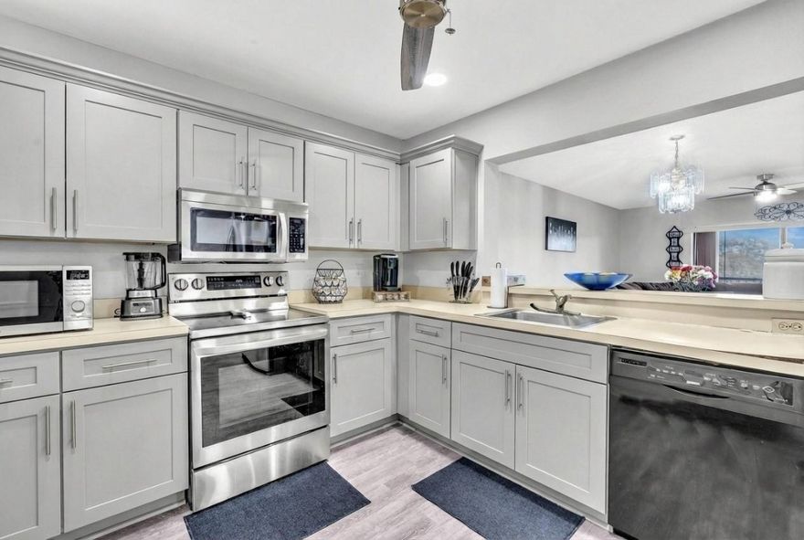 Currently, the ONLY available unit is Saxon Woods! This spacious split floor plan, 3-bedroom, 2-bath condo features stainless steel appliances, vinyl flooring, and a screen in patio. Washer and Dryer in the unit!  The building has passed the 40-year inspection. The roof was replaced in 2025. Located near parks, shopping areas, and major highways. Great for owners or investors! Gray kitchen picture has been virtually modified.