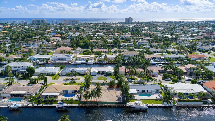 Rare Venetian Isles, Deepwater Lot with 90’± of waterfrontage, offering a rare opportunity to build your dream estate. Perfect for boating enthusiasts, this exceptional property is just minutes from the Hillsboro Inlet, providing quick ocean access. This .20± acre lot includes a full set of architectural plans for a 5,502± SF Coastal-Inspired residence by Askari Homes, making it an ideal opportunity to build without delay. Comes complete with a new 90' concrete dock and raised cap.