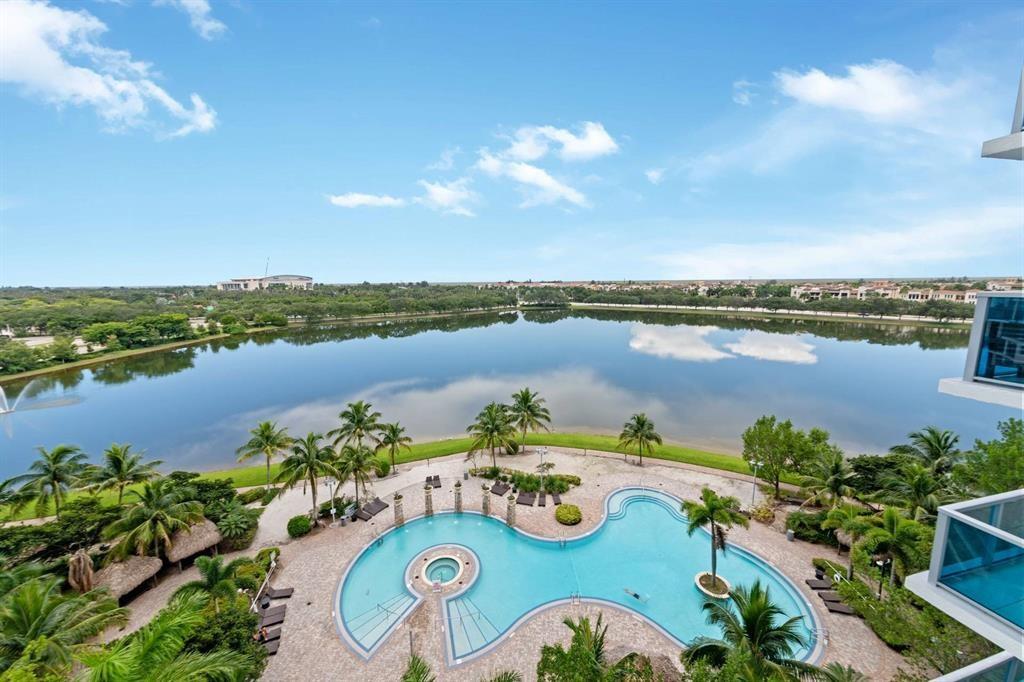 Welcome to the heart of Sunrise! This beautifully maintained corner unit at Tao Sawgrass offers stunning panoramic views—you can even see the Panthers Arena right from your home! Enjoy a spacious split-bedroom floor plan with floor-to-ceiling impact windows, an open-concept kitchen with granite countertops, Italian cabinetry, and stainless steel appliances. The primary suite features dual sinks, a soaking tub, and separate shower. Relax on your private wraparound balcony overlooking the city skyline and serene lake views. Tao Sawgrass is a resort-style community with luxury amenities: pool, hot tub, gym, sauna, tennis courts, business center, and more. Prime location—walking distance to Sawgrass Mills Mall, fine dining, and entertainment, with easy access to major highways.