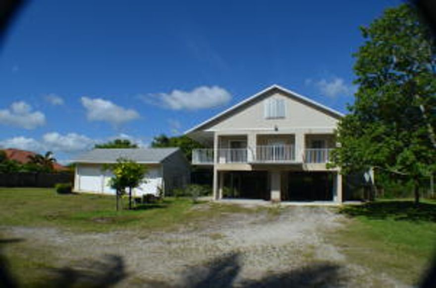 This is a rare opportunity in the Hobe Sound Gomez area! This shows in the tax rolls as a 2/2 but it also has 2 bedrooms upstairs in the attic which is finished with a full bath as well. The lot is 1 acre and has an area already filled and ready to have your dream home built! The 864 sq Ft 3 car garage is adjacent to the elevated guest house. New A/C in 2014! All sizes are estimates and buyer to verify.