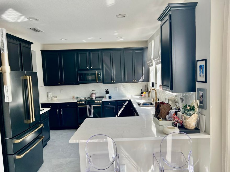 Welcome to an extraordinary opportunity in the heart of West Palm Beach — a fully reimagined, designer-curated luxury residence at 1717 Borrego Way, Unit 4. This stunning three-level townhome offers 4 bedrooms, 3.5 bathrooms, and a spacious 2-car garage, seamlessly blending modern sophistication with high-end custom finishes throughout. Every detail has been thoughtfully upgraded to deliver a truly elevated living experience. Step inside to a beautifully enhanced entry foyer featuring new flooring and refined millwork details that set the tone for the entire home. The first level includes a private guest suite with improved functionality and a fully upgraded bathroom featuring sleek frameless glass shower doors. The second level showcases a showstopping chef's kitchen designed for both beauty and performance. Highlights include custom cabinetry with updated hardware, a built-in pantry, designer backsplash, new flooring, and luxurious countertops. Top-of-the-line appliances include a premium Café Appliances suite and a panel-ready Cove dishwasher, creating a seamless and sophisticated aesthetic. Retreat to the expansive primary suite, complete with custom closets and a fully renovated spa-inspired bathroom featuring new flooring, designer tilework, custom cabinetry, upgraded plumbing fixtures, and curated lighting. Thoughtful touches such as electric blackout shades and custom drapery pockets add both comfort and elegance. Additional upgrades include: • New Samsung stackable washer and dryer with custom cabinetry • Fully renovated powder room with designer finishes • Custom closets in multiple bedrooms • Whole-home water filtration system • Smooth-finish walls and freshly painted interiors throughout • Updated interior doors and hardware • Epoxy-coated garage floors, built-in storage, and upgraded garage system (MyQ compatible) • Integrated alarm system for peace of mind Residents enjoy access to resort-style amenities including a pool, fitness center, and a 24-hour manned security gate, offering both luxury and convenience.    Perfectly positioned just minutes from downtown West Palm Beach, pristine beaches, fine dining, and world-class shopping, this exceptional residence delivers the ultimate in South Florida living.