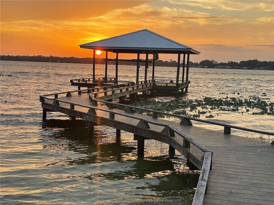 Perfect waterfront Lakehouse situated right on Lake Francis, a 539acre sandy bottom lake! Perfect for 2 families to share or bring your inlaws! 2/1.5 downstairs & 2/1 upstairs! Each floor has a kitchen, living areas, and bathrooms. Many upgrades to this home including two lovely bathrooms on the lower level, one with wheel-chair accessible shower, and big soak tub. Granite counters in the kitchen and newer appliances. Lovely lakefront porch 12x29 with 3 rolldown bay doors! Great for storing your lake toys! 2018 Fresh 4x90 Dock with composite decking and 24x24 boathouse w boat lift!  Upper level also has a screened balcony. Fish, ski, kayak or paddle board in a matter of seconds everyday, after work or all weekend long. Short drive from either coast with plenty to do and amazing sunsets!