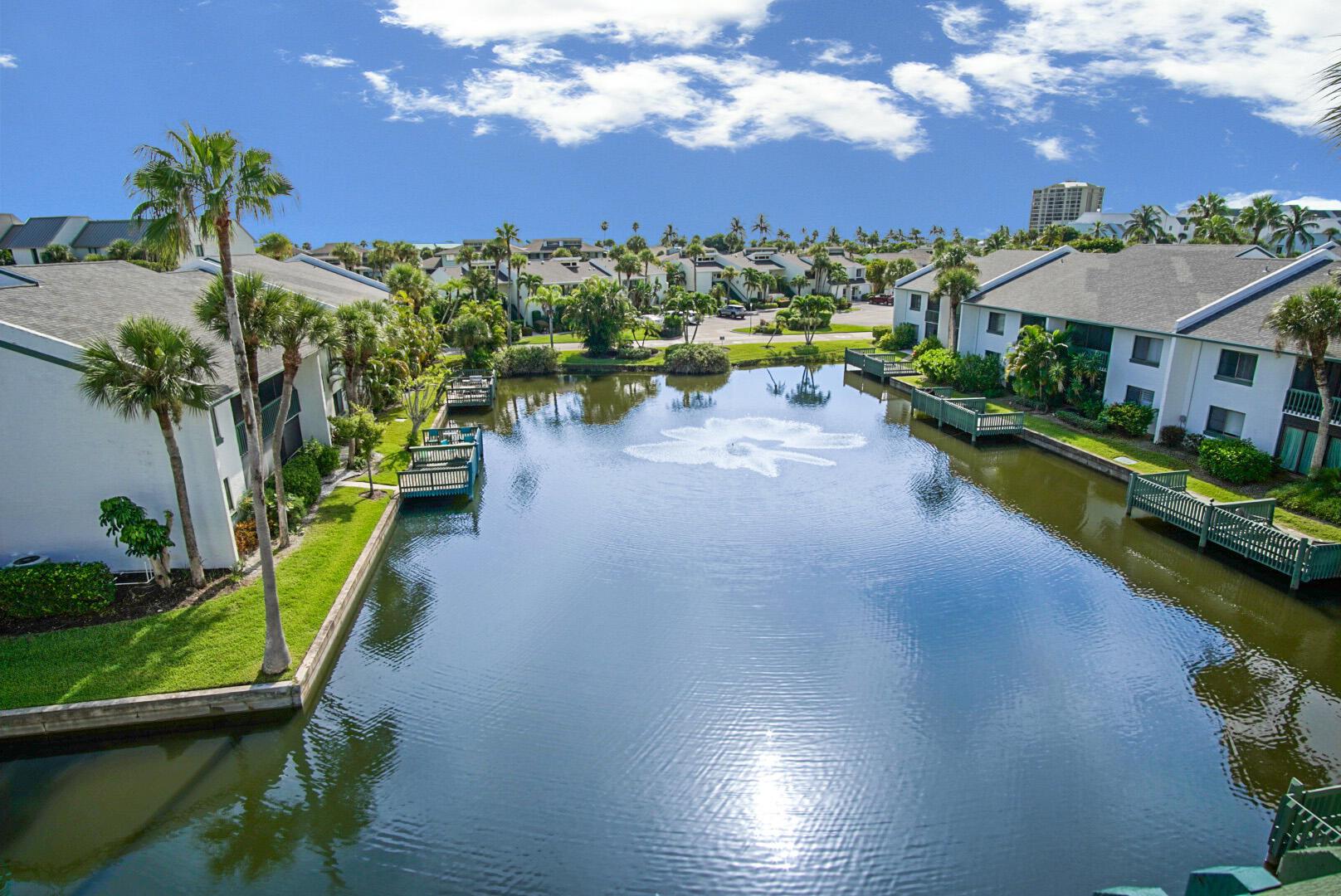 Gorgeous 4th floor 2 bed/2 bath unit features a beautiful quiet view from lanai overlooking the pond with slight ocean view. Turnkey top floor condo features vaulted ceilings, polished tile floors and plenty of space with great rental potential. New roofs in 2022, new HWH in 2023, new full size washer/dryer 2023, new refrigerator and TV 2023. Smart lock and thermostat also installed so you can keep track of the condo when not home. Enjoy beautiful Ocean Village and the many amenities it has to offer including 3500 feet of private beach, 9-hole 3 par golf course, bocce ball, shuffle board, pickleball, tennis, multiple pools and hot tubs, new fitness center and clubhouse, NEW restaurant and tiki bar, and NEW resort style main pool for 2025, 24 hour gated community.