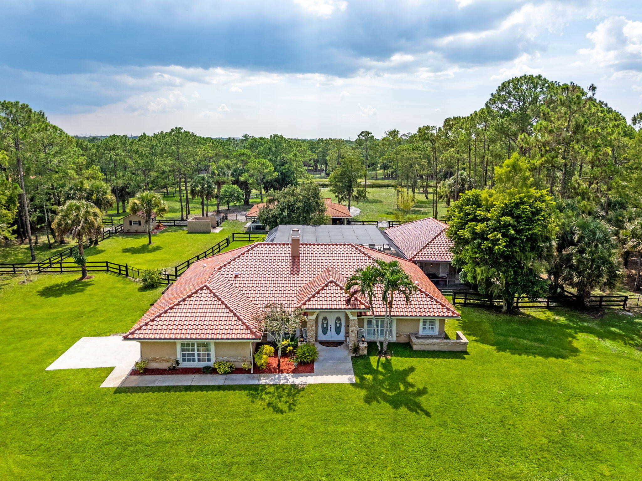 Deer Run is the Epitome of equestrian living with Miles and Miles of trails to be enjoyed and only a street away from the competition venue of White Fences . As you enter in through the gate and drive up the long driveway taking in the lush Florentine grass with the newly installed high Sheen Barcelona barrel tile roof 2025 it will spark your intrigue. When you enter through the double doors into a high vaulted ceilings with can lighting and a stone fireplace the feeling of home feels like a blanket of warmth. Newly installed luxury plank vinyl flooring throughout the home. The kitchen has stainless steel appliances with a new hand designed countertops with lifetime warranty. New 2025 HVAC . Split floor plan with the two bedrooms large enough to hold a sleigh KING sized bed. The Main