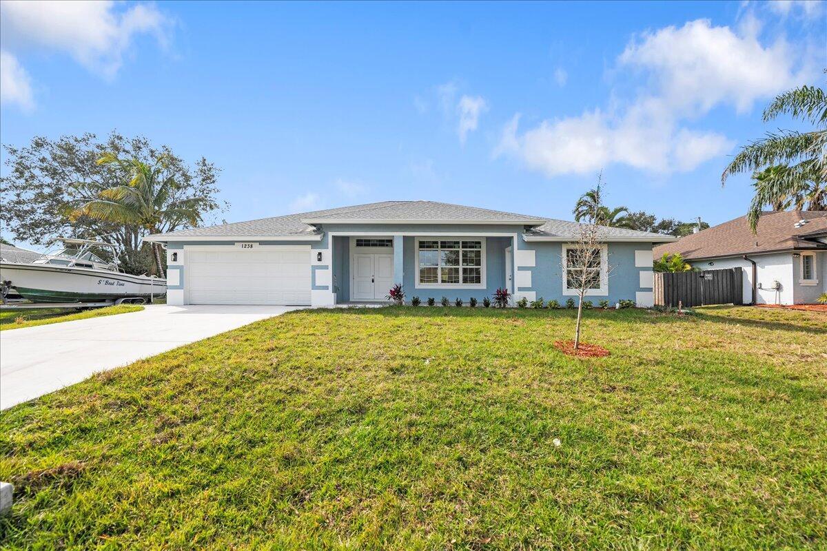 New construction house in desirable area of Port St Lucie. House boasts 4 bedrooms and 3.5 bathrooms. It has an outdoor shower and tons of room for a pool. House has tons of upgrades. Ten foot ceilings in common area, open, modern floor plan, impact windows, waterfall style kitchen island, granite backsplash, upgraded granite in kitchen, bathrooms and window sills, porcelain tile throughout the house, bathroom tiled floor to ceiling. Soft close kitchen cabinets, seamless glass shower enclosures, modern lighting fixtures and LG kitchen appliance package. over $60,000 in upgrades already included in the house.