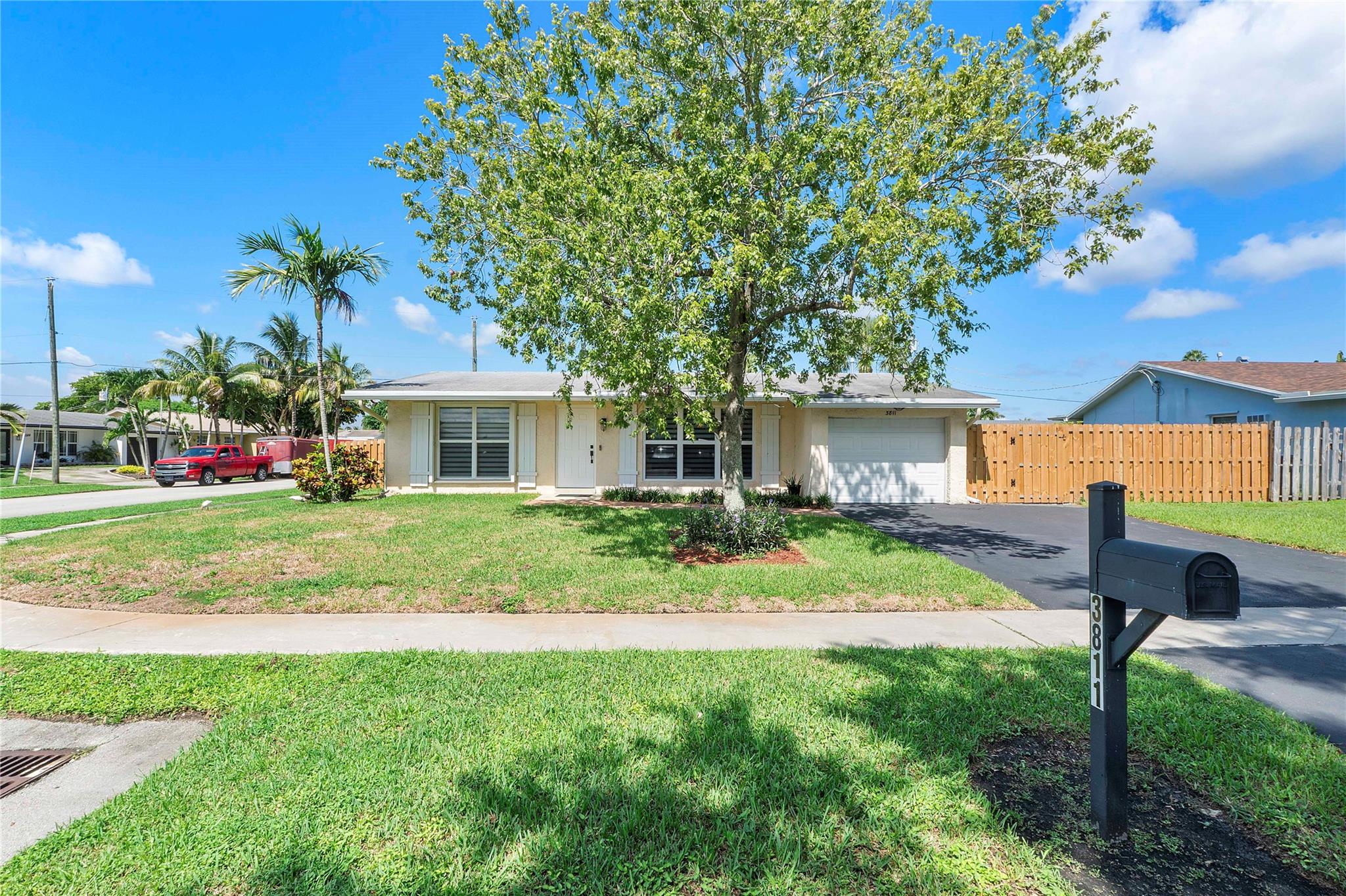 Welcome to this inviting 3BR/2BA home on a spacious corner lot with a large fenced yard, perfect for outdoor living and entertaining. The beautifully remodeled kitchen features custom cabinetry, gas stove, and stainless appliances, flowing into bright and comfortable living areas with a warm, neutral style. Enjoy the enclosed patio for year-round relaxation, with most impact windows and sliders plus shutters for added peace of mind. The stove and water heater run on gas, helping reduce electricity costs. 2016 roof has been maintained with new soffits and gutters, offering plenty of remaining life. Modern fans, updated baths, and a true 1-car garage add comfort and convenience. With no HOA and prime location near Sawgrass Mills and Sawgrass Expressway, this is the perfect place to call home