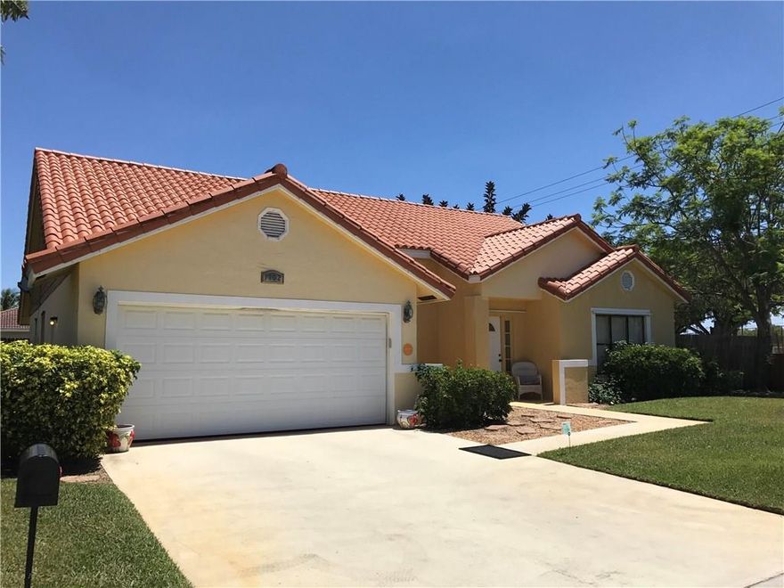 Amazing 3 bedroom, 2 bath home with 2 Car Garage in exclusive Vernon Heights.  Vernon Heights, located between downtown WPB and Delray, boosts its own private community park and boat dockage with access to Lake Charles and Lake Ida and is next to new construction selling for up to $100ks more!  This large executive home (the original Vernon Heights model home) is located on a quiet street with updated kitchen, baths and flooring.  All this and low HOA at $38 per month. Bring your fussiest buyer!