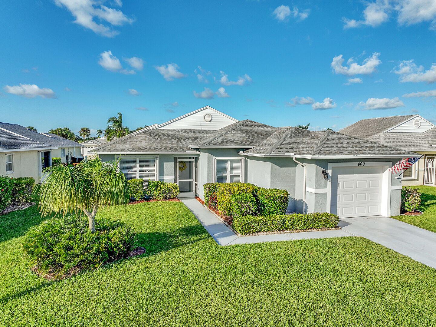 Priced to sell. Ready to move in. Gently used Two bed two bath CBS home in an active 55+ gated community of Palm Grove. As you step inside, notice the perfect blend of comfort and style, the beautiful porcelain floors, granite counters in kitchen and baths, newly remodeled bathrooms with porcelain tile and glass door showers. Enclosed lanai for year round use. AC, roof, shutters and garage door are 2018. New retractable garage screen and Washing machine in 2025. Low Monthly HOA includes lawn care, irrigation, sewer, water, cable, internet and gated access. Enjoy the Florida Lifestyle and planned activities in Palm Grove. The ocean, rivers, parks, entertainment, shopping, medical are close by. (Note: gate clearance required for entry into Palm Grove.)