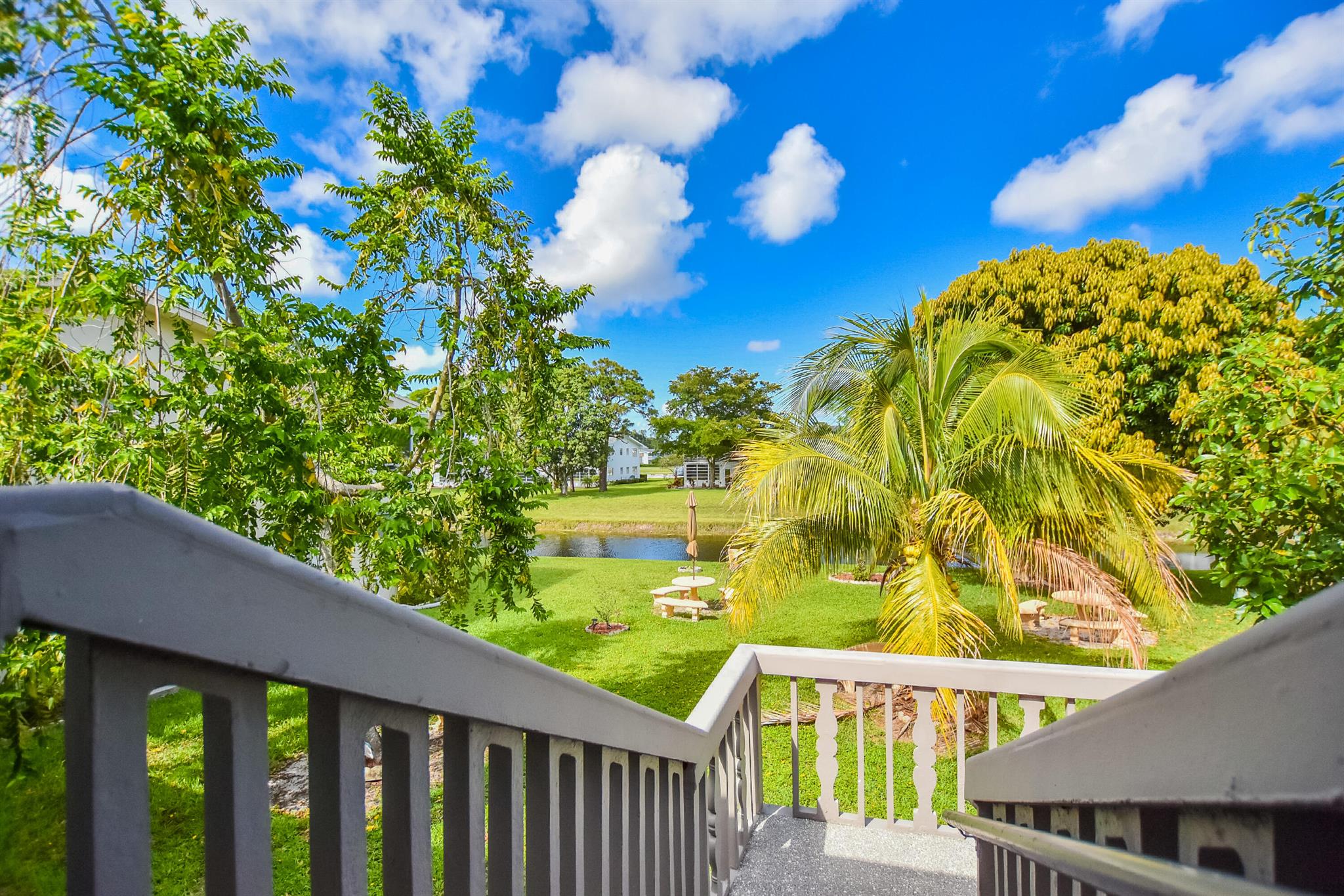 How does cocktails on your private screened enclosed balcony overlooking plush gardens, fruit trees, exotic birds wildlife and flowing canal outside your primary bedroom with walk in closet sound? This rare vacancy includes a ''State of the art'' gym membership AND HBO w basic cable.Our Courtyards offer ample stone tables and umbrellas for family BBQ and fresh herbs flowers and a delightful ylang ylang tree make this home magic.Emotional support pets are welcome & the association is non smoking to protect our lungs. Newly remodeled with modern Gray plank tile floors, 6 panel doors, glass shower doors, newer appliances under 1 year, circulating fans, & dimmers throughout for romantic ambiance.Entire condo has FRESH PAINT and NEW floors.