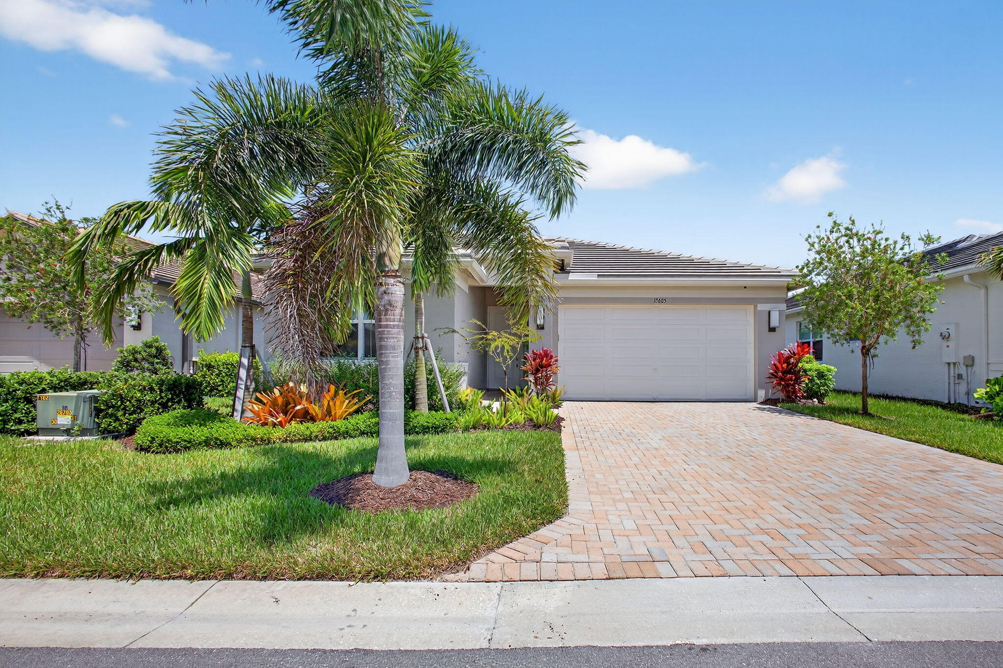 Why wait to build when this beautifully upgraded Sandpiper model is ready and waiting for you--complete with tranquil garden views and the perfect blend of style and comfort.Step inside and immediately feel at home in the bright, open layout where every detail has been thoughtfully designed. Gorgeous upgraded tile flows seamlessly throughout the space, complemented by soft lighting from recessed ceiling fixtures and designer light accents. The heart of the home--an inviting great room--is dressed with elegant custom drapes and Hunter Douglas shades, offering both warmth and privacy.The kitchen is as functional as it is beautiful, with upgraded cabinetry and plenty of space for gatherings. Just off the main living area, the enclosed patio invites you to relax, featuring extended paver