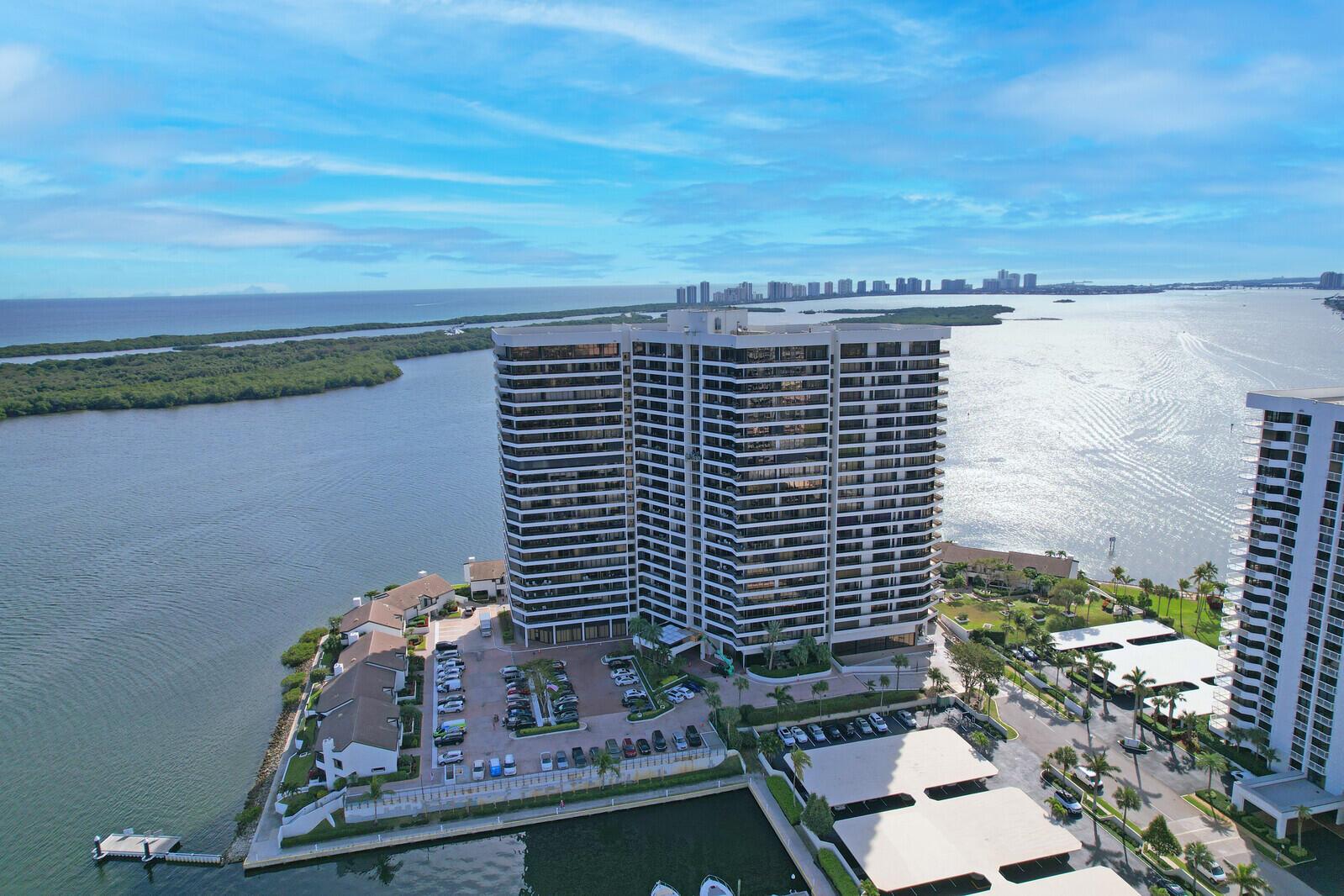 TOTALLY PRIVATE LOCATION with plenty of space and spectacular ocean sunrises. Fantastic water view from the 12th floor overlooking OPC marina, Lake Worth Lagoon, Singer Island and Intracoastal waterway with 1000 sq feet of additional balcony space. Preferred NE exposure allows for sunny mornings and afternoon shady balcony. Great floor design with split bedroom plan, all large rooms, large storage room, separate utility room, walk in closets, wet bar, entry foyer with half bath, twin A/C units, 8'8' ceilings, floor to ceiling glass, two great garage parking spaces close to building entry and elevators. Building putting in impressive new pool area along with many other building updates: gym, offices, lobby, social room and more. Old Port Cove is conveniently located in North Palm Beach