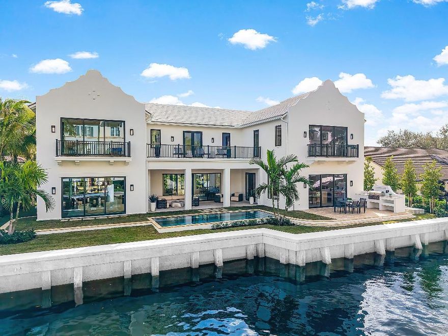 A Masterpiece of Waterfront Luxury on a Private Street.
Experience the pinnacle of coastal sophistication in this newly completed custom waterfront estate by the renowned Shoreline Builders. Privately positioned on an exclusive street just moments from the Intracoastal, this exceptional residence offers approximately 5,260 square feet under air and 6,800 total square feet of exquisitely designed living space. Classic West Indies architecture meets a warm, modern coastal interior; every detail thoughtfully curated with designer finishes throughout. A dramatic entry welcomes you through floor-to-ceiling glass doors and windows, bathing the home in natural light and immediately framing tranquil water views. Designed for effortless entertaining, the main level features a seamless flow between the expansive club room, family room, dining area, and chef's kitchen each space opening to the backyard and waterfront beyond. The custom kitchen is outfitted with premium European cabinetry, a Wolf and Sub-Zero appliance suite, an oversized walk-in pantry, and adjacent laundry for ultimate convenience. A first-floor guest suite with a full cabana bath offers ideal flexibility for visitors or waterfront entertaining.
Upstairs, the primary suite is a true retreat, complete with a morning bar, private balcony overlooking the water, and extraordinary his-and-hers closets of unparalleled scale. The spa-inspired primary bath showcases a freestanding soaking tub, oversized walk-in shower, and dual vanities finished to perfection. Three additional en-suite bedrooms complete the upper level, including a stunning VIP suite with breathtaking Intracoastal views just steps away.
Designed for seamless indoor-outdoor living, the resort-style backyard features a spectacular pool and spa with Pebble Tec finish, natural coral stone pavers, and lush Zoysia turf. The covered loggia is an entertainer's dream, offering automated retractable screens, cypress wood ceilings, a fireplace, and a fully equipped summer kitchen, perfect for year-round waterfront gatherings.
Additional features include - Natural white oak hardwood floors throughout
" Designer lighting, hardware, and finishes at every turn
" Control4 home automation for lighting, audio, climate, shades, and security
" Bar and media room pre-wired for theater-quality sound
" Five en-suite bedrooms with walk-in closets
" Dual laundry rooms
" Elevator-ready construction
" Impact windows and doors, spray foam insulation, and AC-ready garage with car-lift capability
Just one lot from the Intracoastal with approximately 100 feet of water frontage and quick ocean access via the Boynton, Palm Beach or Boca Inlet, this exceptional residence is ideally located minutes from downtown Delray Beach, world-class dining and shopping, and the pristine beaches of Ocean Ridge and Delray.
Built with uncompromising craftsmanship, refined elegance, and the finest materials, this private waterfront estate defines modern coastal luxury at its highest level.