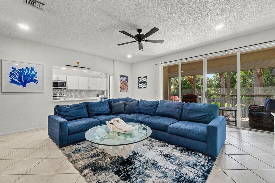 Just steps from the Intracoastal, this beautifully updated second-floor condo blends coastal living with modern design. Inside, you'll find thoughtful details throughout--custom built-in cabinetry, a stylish accent wall, and sliding glass doors that fill the home with natural light. The remodeled kitchen is a true highlight, featuring an oversized quartz island, generous cabinetry with a pantry closet, newer stainless-steel appliances, and a wine fridge. The spacious primary suite includes a large walk-in closet and a serene bathroom with a shiplap accent wall, soaking tub, and separate walk-in shower. The guest wing provides its own walk-in closet, a double-door linen closet, and a comfortable bedroom retreat.