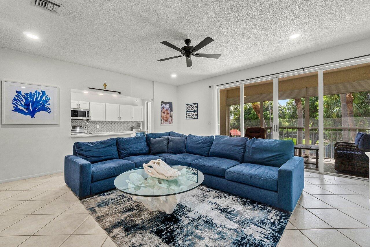 This amazing second floor condo is steps away from the intracoastal waterway. Walking into this home you will notice the attention to detail with built in storage cabinetry, a modern accent wall, and an abundance of natural light with an entire wall of sliding glass doors. The kitchen has been remodeled opening the island with extensive quartz countertops, generous cabinet space. Other kitchen features are newer stainless-steel appliances, pantry closet, plus a wine fridge. Primary bedroom is substantial on space, has an abundant large walk-in closet, step into the bathroom featuring a coastal vibe with a shiplap wall, a welcoming tub plus a separate walk-in shower. Guest bedroom hallway has a double door linen closet plus another walk-in closet.