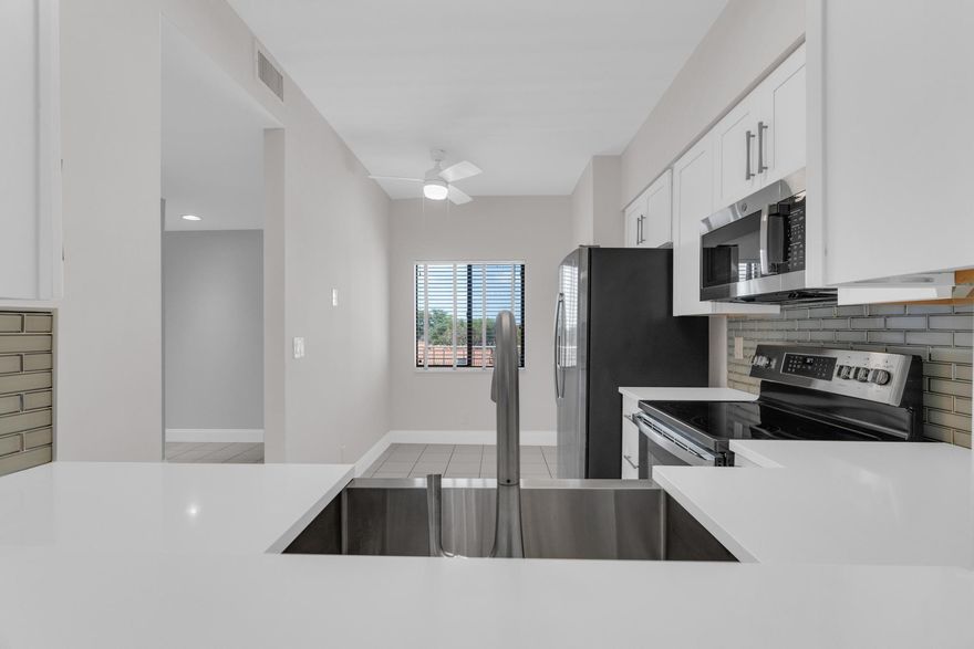 Welcome home to your remodeled condo in a resort style active 55+ community. This top floor pent house unit has extra tall ceilings and classy updates with a breath taking view over the lake. The home showcases a brand new kitchen, bathrooms, floors and there is an In-unit Washer/Dryer. When you come to visit, make sure you stop by the remodeled club house to see all the activities, fitness rooms, card and billiard rooms. The pools and pickleball courts will keep you busy for hours. If you decided to venture out, there is shopping and dining only minutes away with Atlantic Ave and the beach directly east of your home. Home is virtually staged and not furnished.