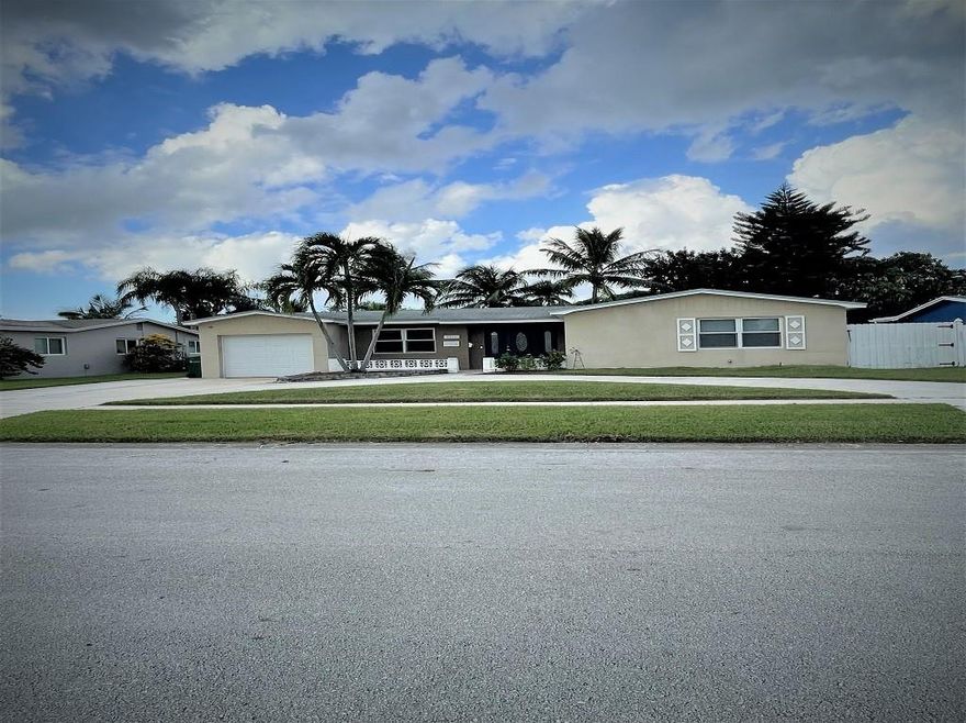 THIS HOME FEATURES COUNTLESS OUTSIDE UPGRADES THAT INCLUDE IMPACT WINDOWS & DOORS, EXTENDED COVERED PATIO, OVERSIZED POOL & PATIO DECK, ENORMOUS CIRCULAR DRIVEWAY WITH ROOM TO PARK A BOAT OR RV. INSIDE THE HOME FEATURES CERAMIC TILE FLOORS & WOOD FLOORS FOR THE 3 BEDROOMS. THE MAIN BATH IS FULLY RENOVATED, AND THE KITCHEN HAS S/S APPLIANCES & WOOD CABINETS. THE FAMILY ROOM & FORMAL LIVING ROOM & PRIMARY BED & BATH ALL FEATURE LARGE-IMPACT GLASS FRENCH DOORS.THE HOME HAS A TANKLESS WATER HEATER AND A 4-YEAR-OLD A/C. THE PROPERTY IS WATERFRONT WITH A LARGE SEMI FENCED YARD, AND PLENTY OF GRASS, FOR CHILDREN AND PETS. THIS SUBDIVISION HAS (NO HOA) OR EXTRA FEES.