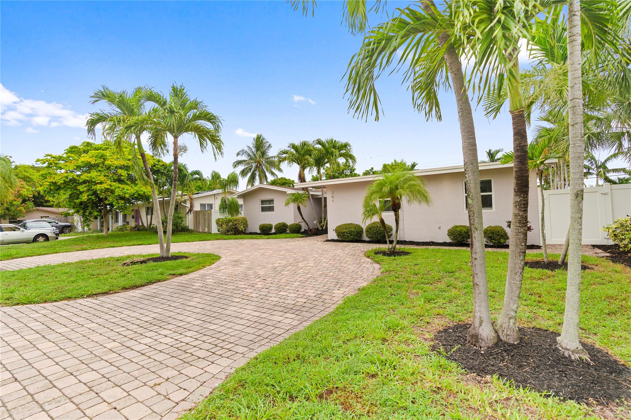 This beautifully updated 4-bed, 3-bath Pompano Beach pool home delivers comfort, privacy, and lifestyle in one of South Florida’s top neighborhoods—perfect for families or multigenerational living near Fort Lauderdale. The split-bedroom design highlights two large primary suites with ensuite baths and walk-in closets—ideal for guests, aging parents, or grown children. One suite offers a private entrance for added flexibility. The open-concept living area flows to a new kitchen with quartz counters, soft-close cabinets, and stainless appliances. Wood-look tile floors, crown molding, and coastal details set a relaxed Florida vibe. Enjoy a heated pool, spa, indoor laundry, plantation shutters, updated baths, and easy access to beaches, golf, parks, shopping, and schools