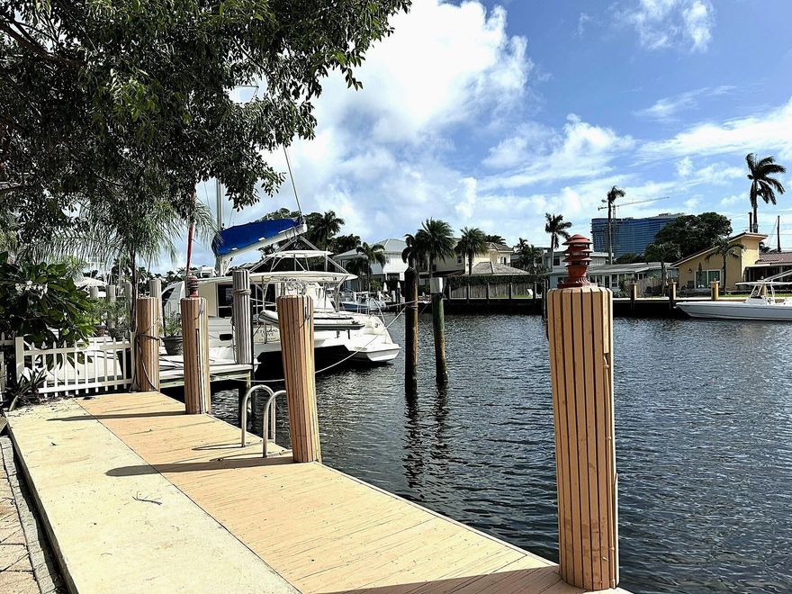 Remarkable Waterfront Home with 80' on the canal with direct access to the Ocean.  Largest lot in the area on the water, corner home rebuilt in 2000 (per owners). This spacious home offers an open concept living room, soaring ceilings with Fireplace, two primary bedrooms (one on each level), 2 additional bedrooms, an entertaining kitchen, oversized laundry room. The surrounding yard has a privacy wall on all sides, mature landscaping, a large patio bar and grill with counter seating. Just a few steps away from the patio to the 80' dock with electric and water service.  The canal is oversized and can accommodate a wide turning vessel.  This peninsula street is accessed by a bridge where you have fast ocean access or the city life in downtown Fort Lauderdale.
