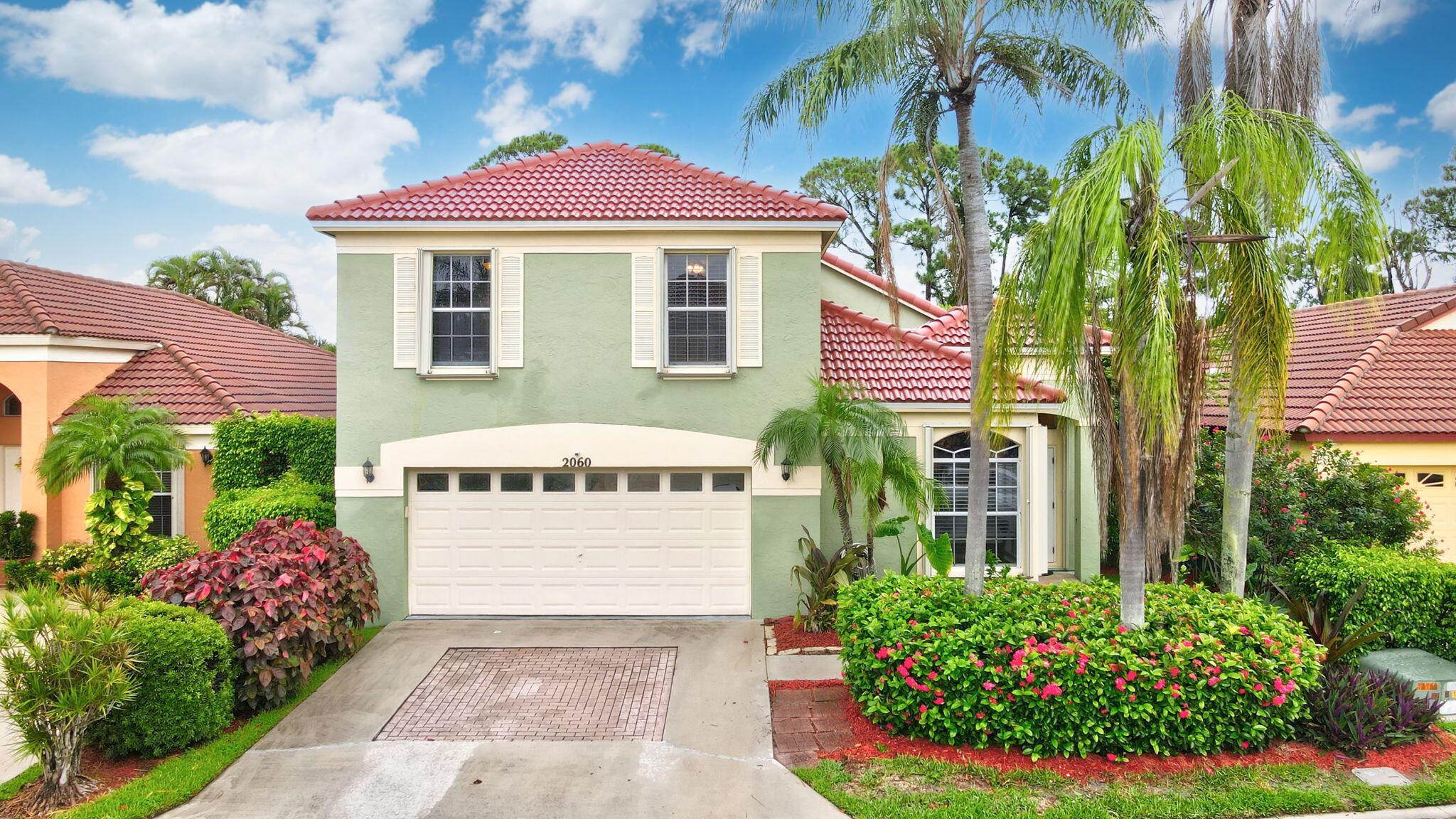 Welcome to your Dream Home in Paradise! Discover this stunning 4-bed, 2.5 bath plus loft 2-story single-family home with a serene green fenced backyard. Step inside to a bright, freshly painted living room featuring cathedral ceilings. The master bedroom is conveniently located downstairs, with sliding doors opening to your backyard sanctuary with a screened and partially covered patio. Get ready in a thoughtfully remodeled master bathroom, offering a solid wood vanity with dual sinks, granite, a jetted tub, and a separate shower. Head upstairs on the recently redone staircase, where a spacious loft serves as a second living area, and the second bathroom offers a modern vanity with dual sinks and an oval tub. New roof (2024) and complete hurricane accordion shutters provide peace of mind.